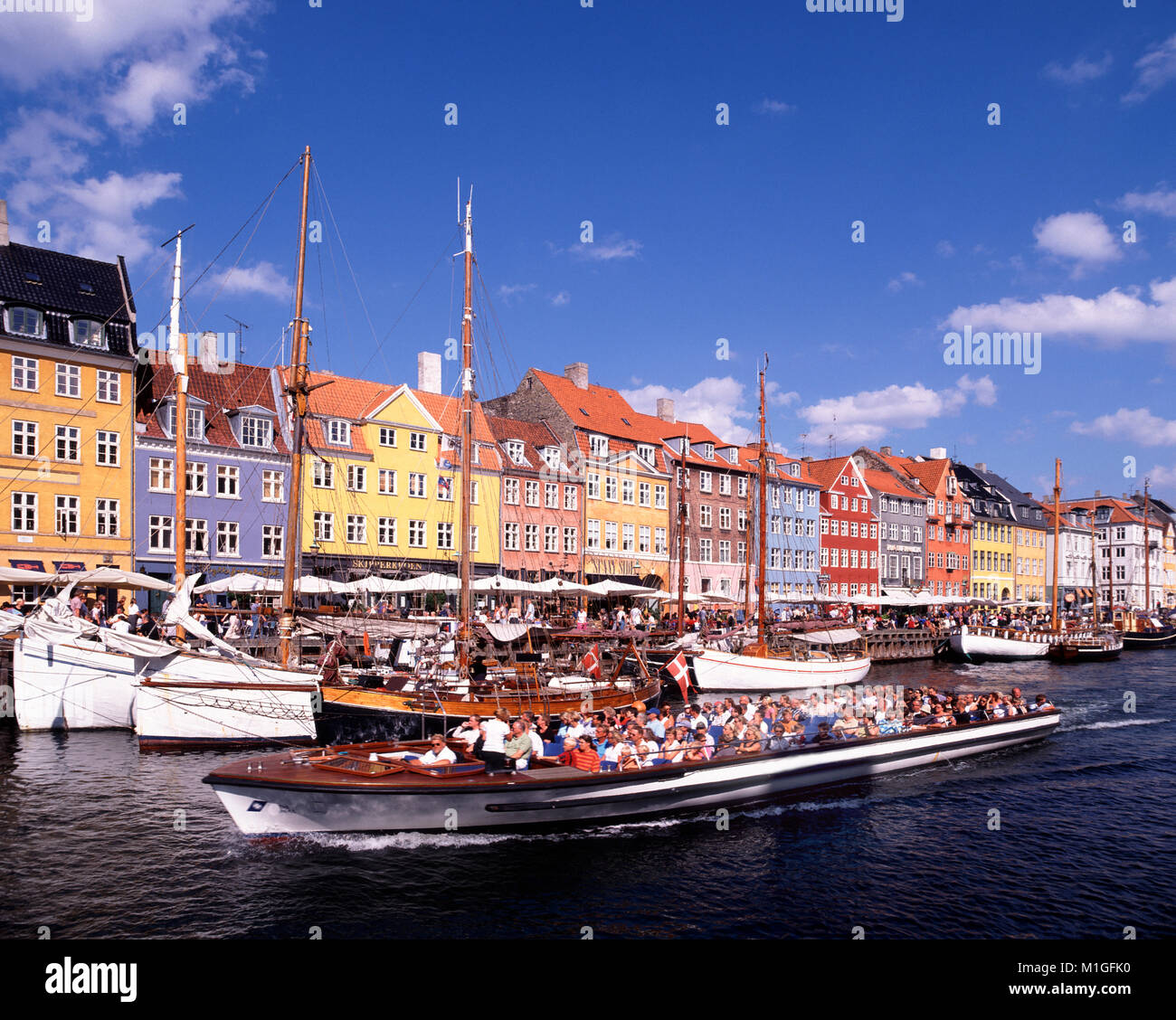 Tourists on pleasure boat, Nyhavn, Copenhagen, Denmark. Stock Photo