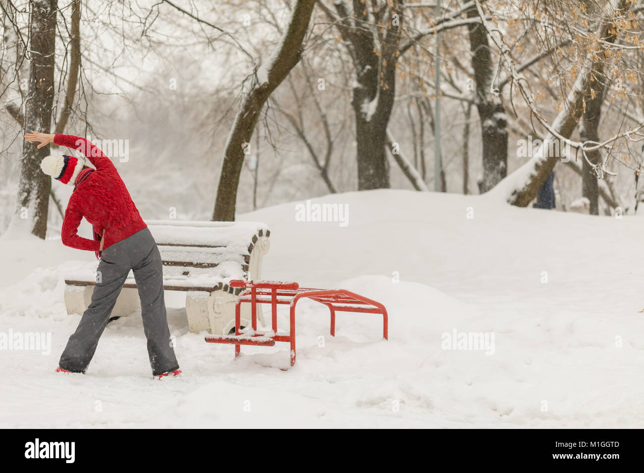 Attractive woman playing sports under the snow Stock Photo