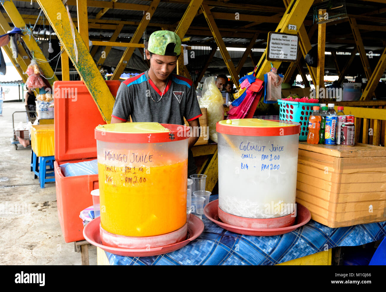 Young vendor selling fruit juice at the market in town centre, Kota