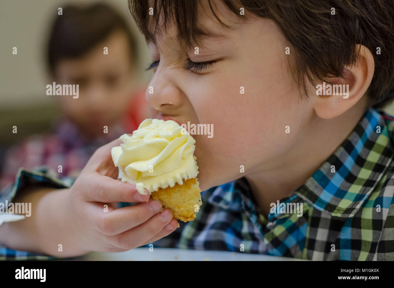 Child eating cupcake hires stock photography and images Alamy