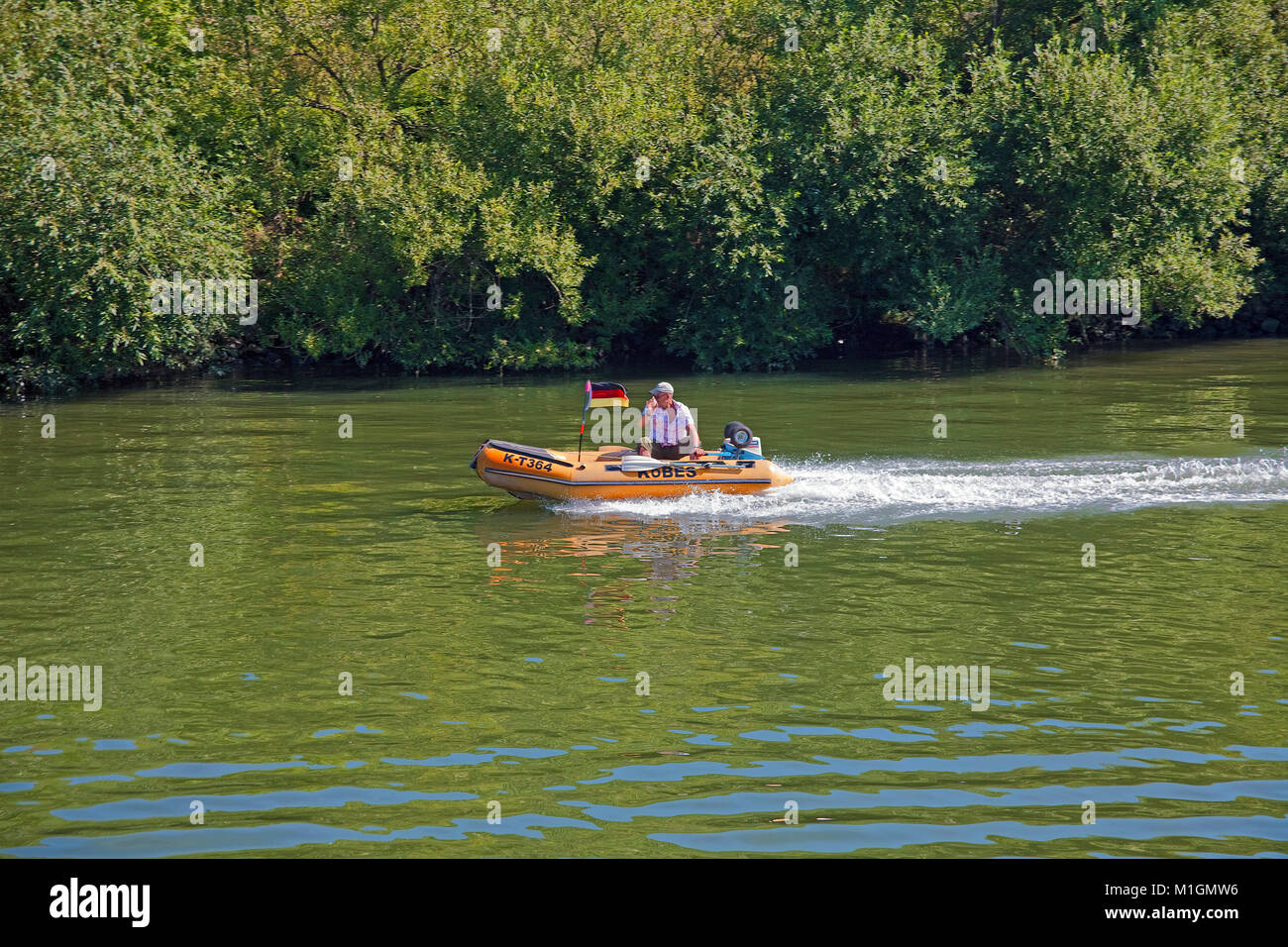 Leisure captain with inflatable boat on Moselle river, Loesnich, Rhineland-Palatinate, Germany, Europe Stock Photo