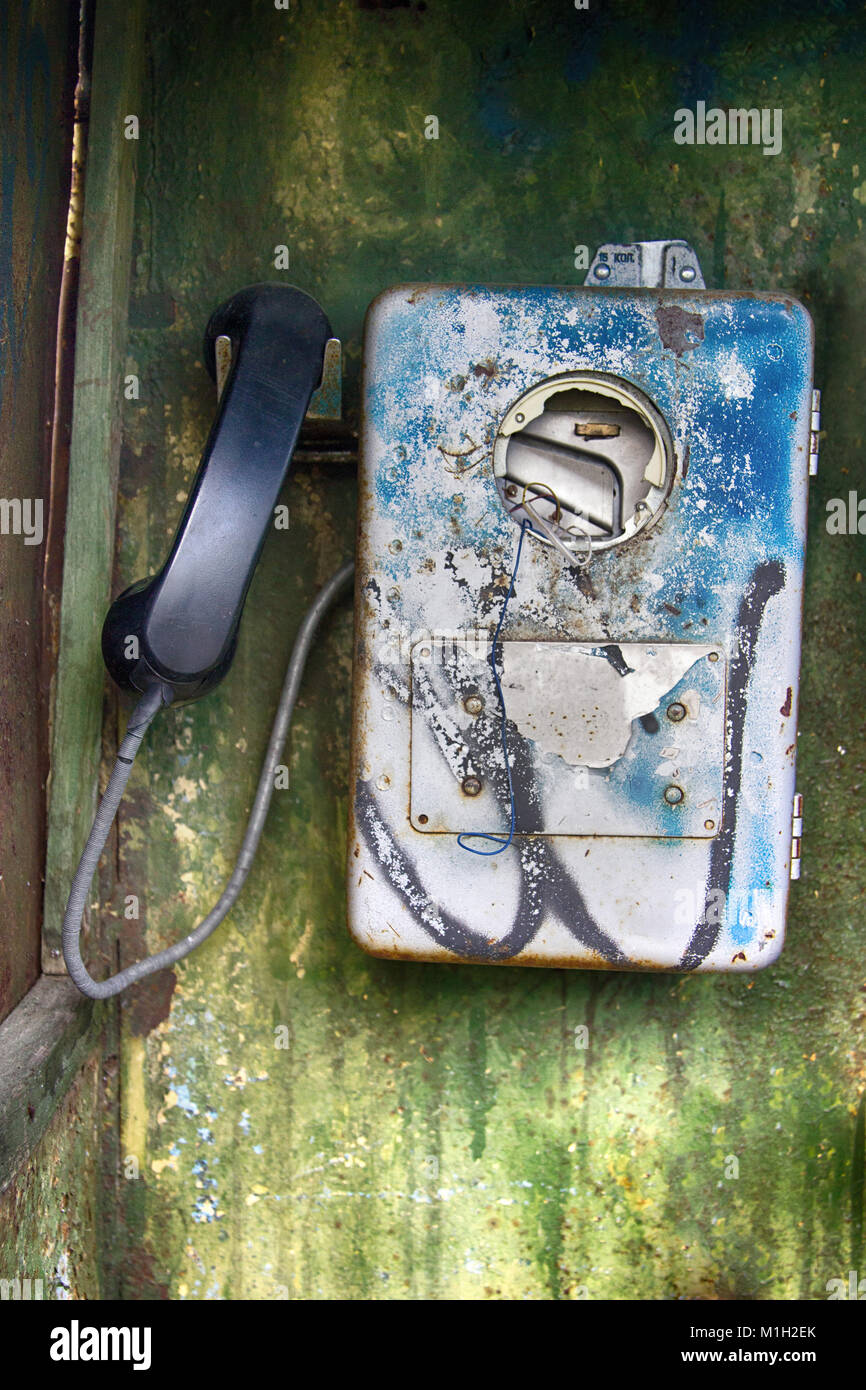 Old broken phone in phone booth. coinbox; pay telephone; callbox