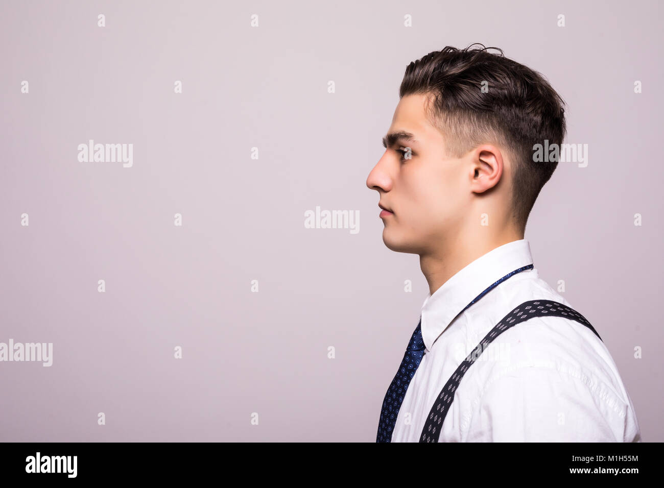 Side View Portrait Of Confident Man With Beautiful Hairstyle In White Stock Photo Alamy