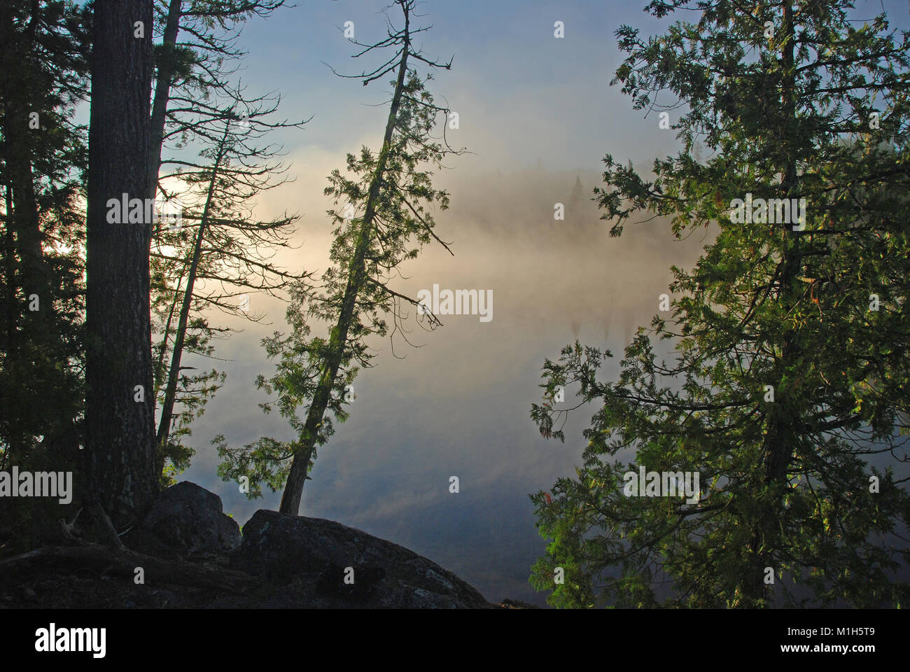 foggy sunrise on Bell Lake in the Quetico Stock Photo