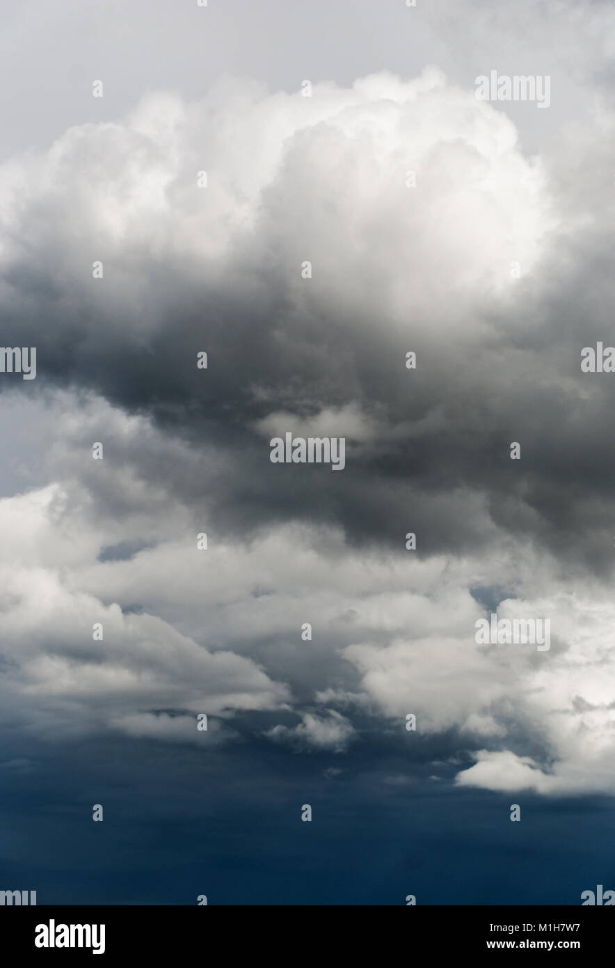 Gray and white storm clouds on hte dark blue sky Stock Photo - Alamy