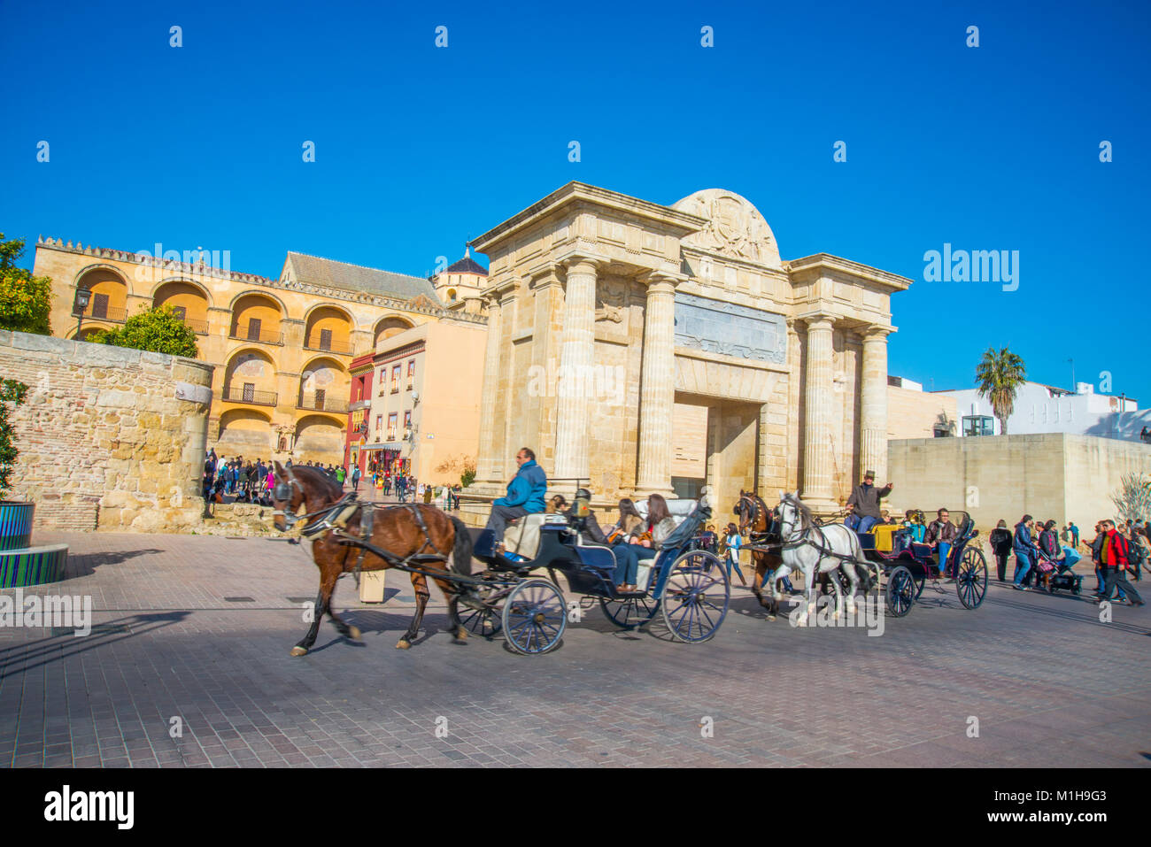 Horse-drawn carriages at Puerta del Puente. Cordoba, Spain. Stock Photo