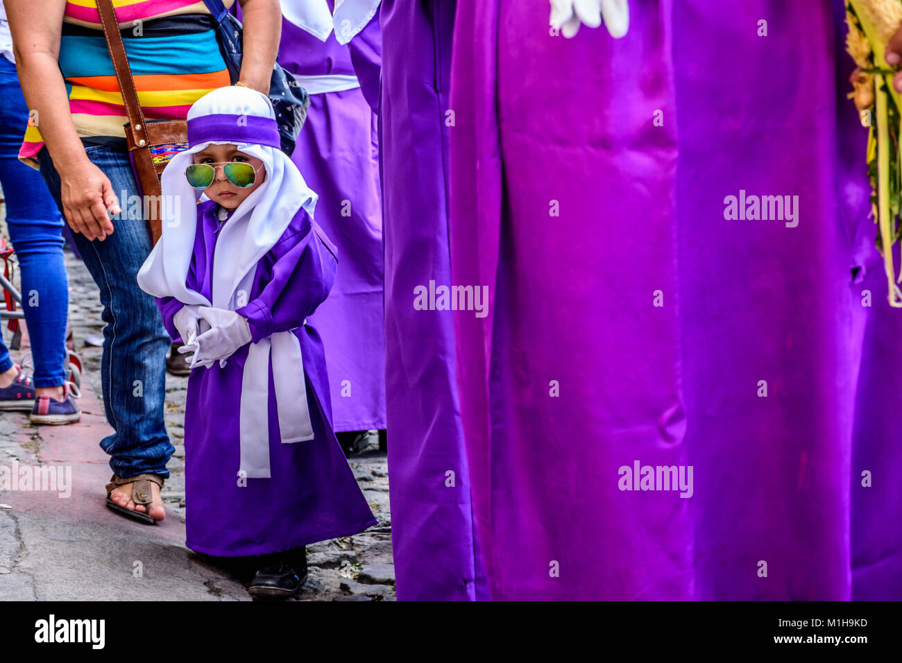 Antigua, Guatemala -  March 20, 2016: Boy in penitent robe in Palm Sunday procession in town with most famous Holy Week celebrations in Latin America Stock Photo