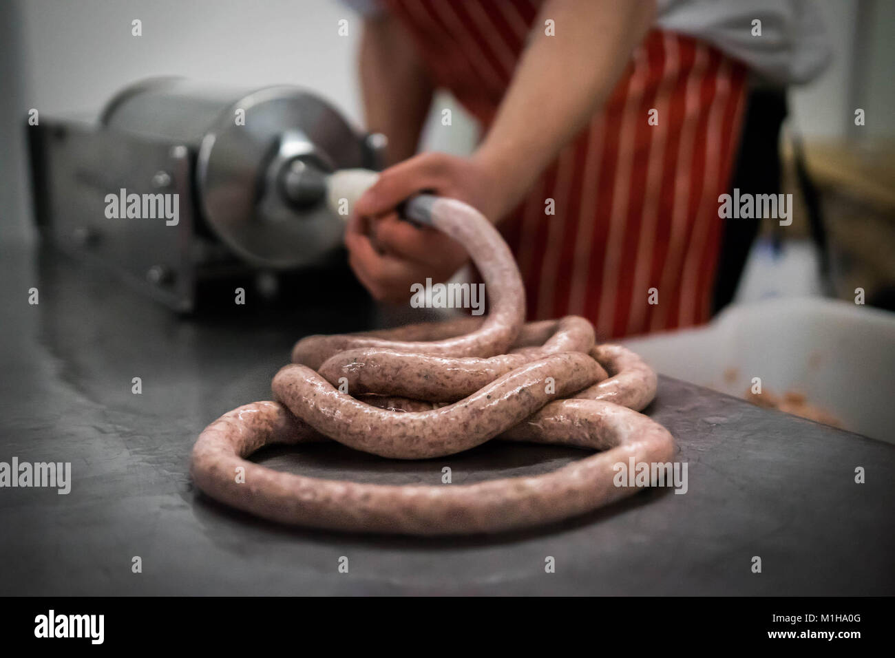 A butcher making sausages Stock Photo