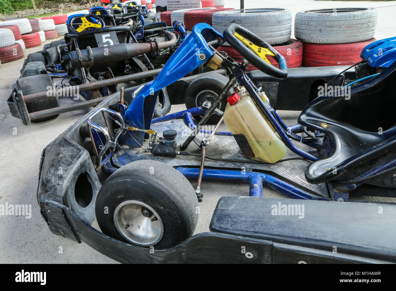 A picture from the go-kart race track. A detail of one kart with the others standing in the line and waiting for the drivers. Stock Photo