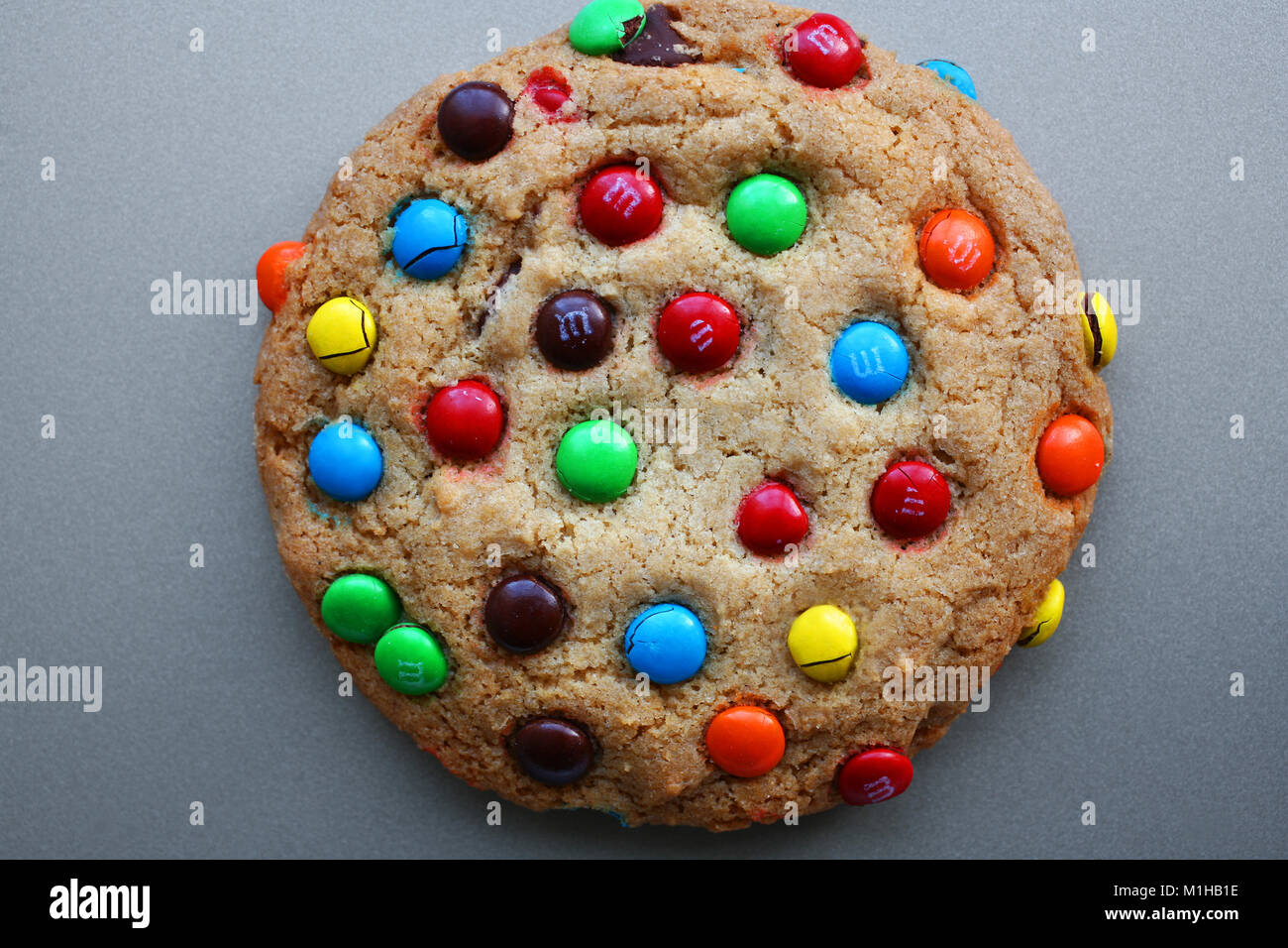 large M&M cookie on baking sheet Stock Photo