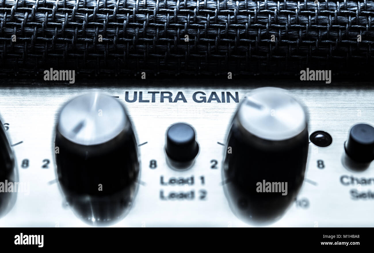 Macro close up of guitar amplifier ultra gain volume level knobs panel