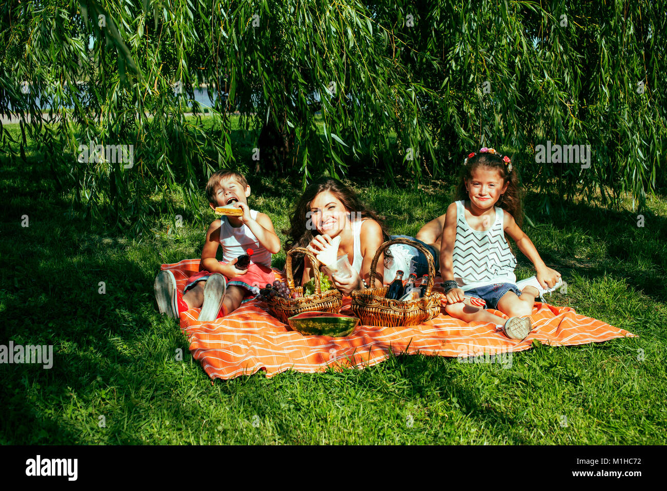 cute happy family on picnic laying on green grass mother and kid Stock ...