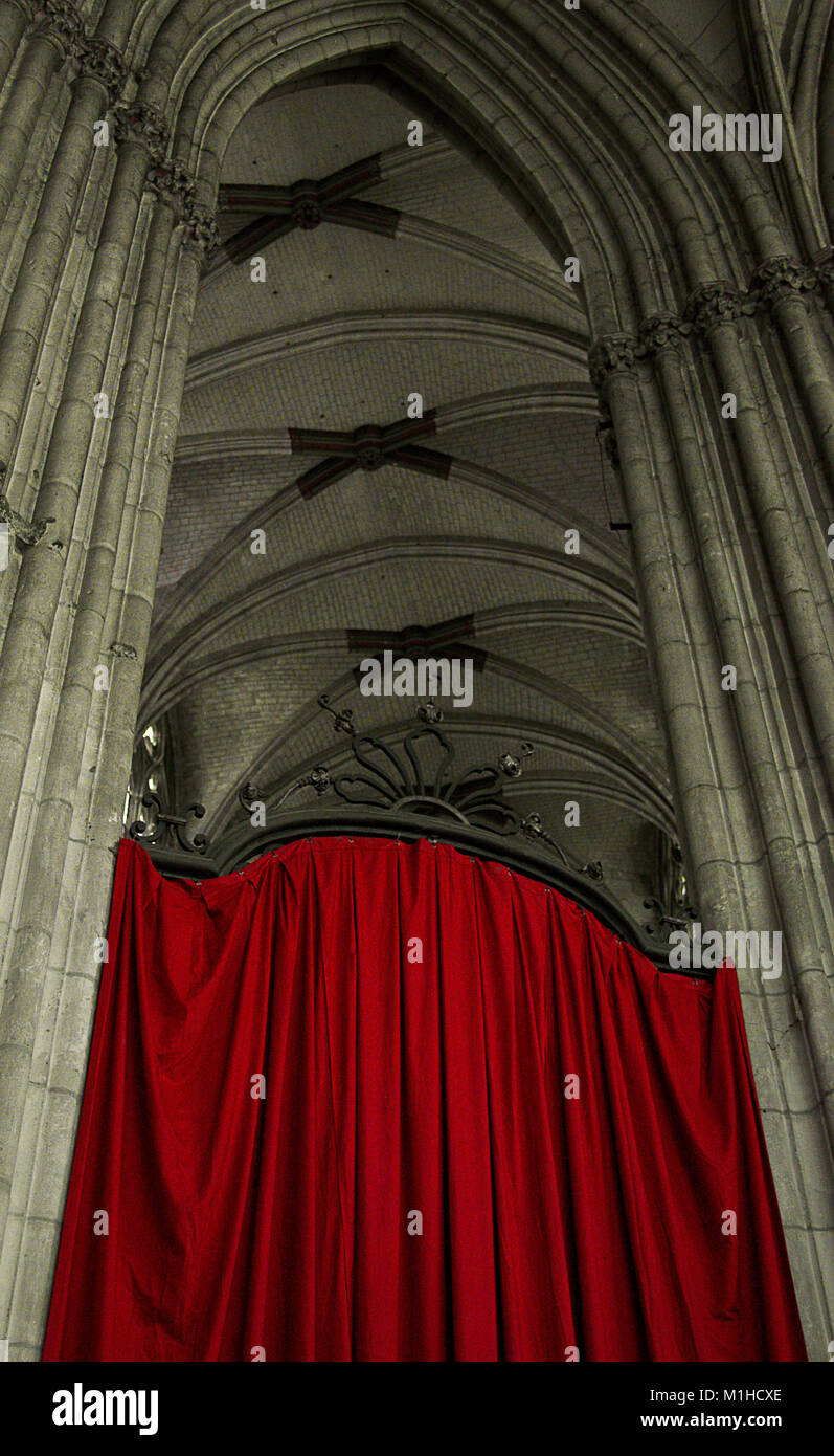 Interior of Norman church at Evreux, France with hanging red curtain Stock Photo