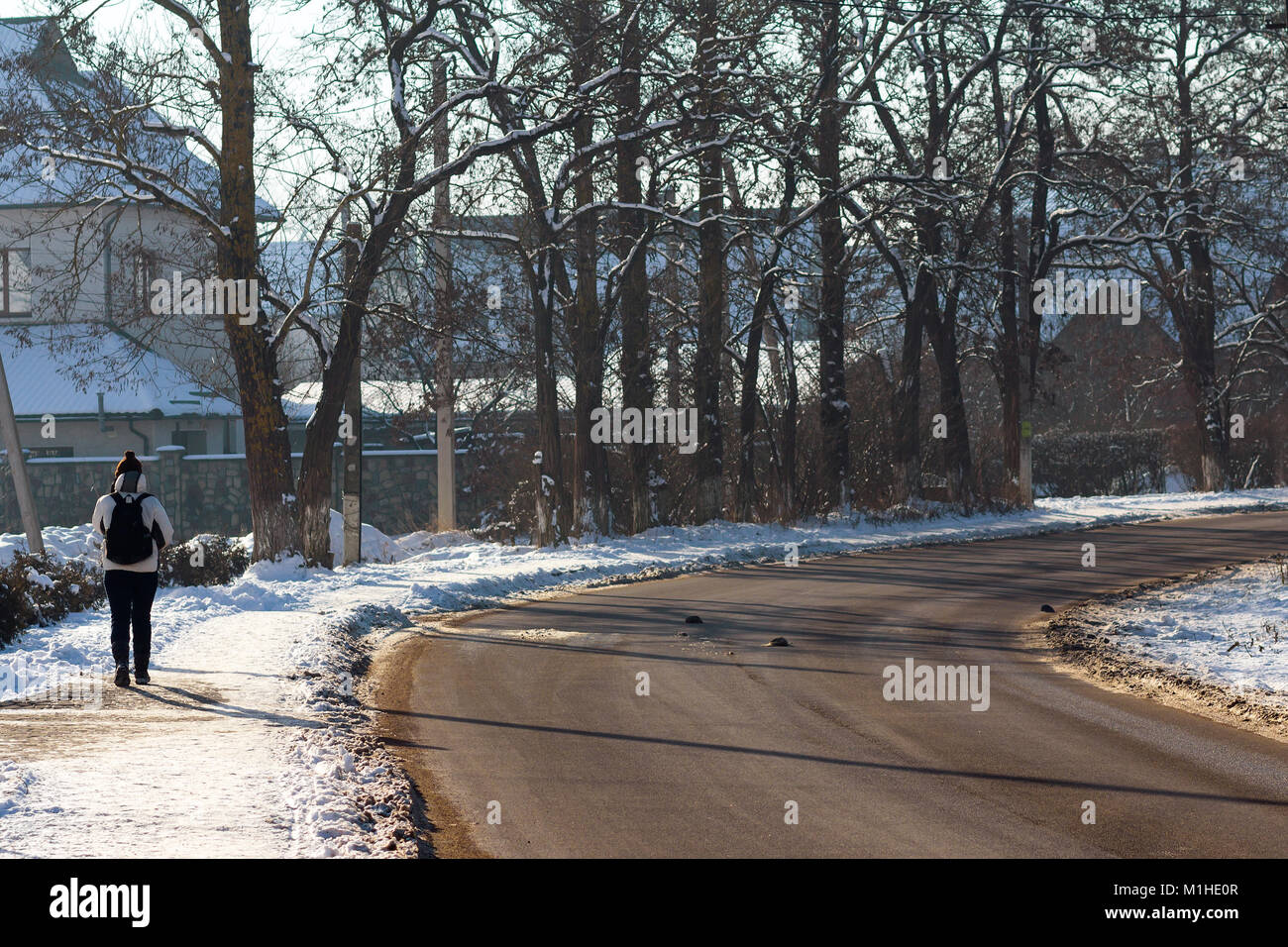 Young lonely person walking on old empty road Stock Photo