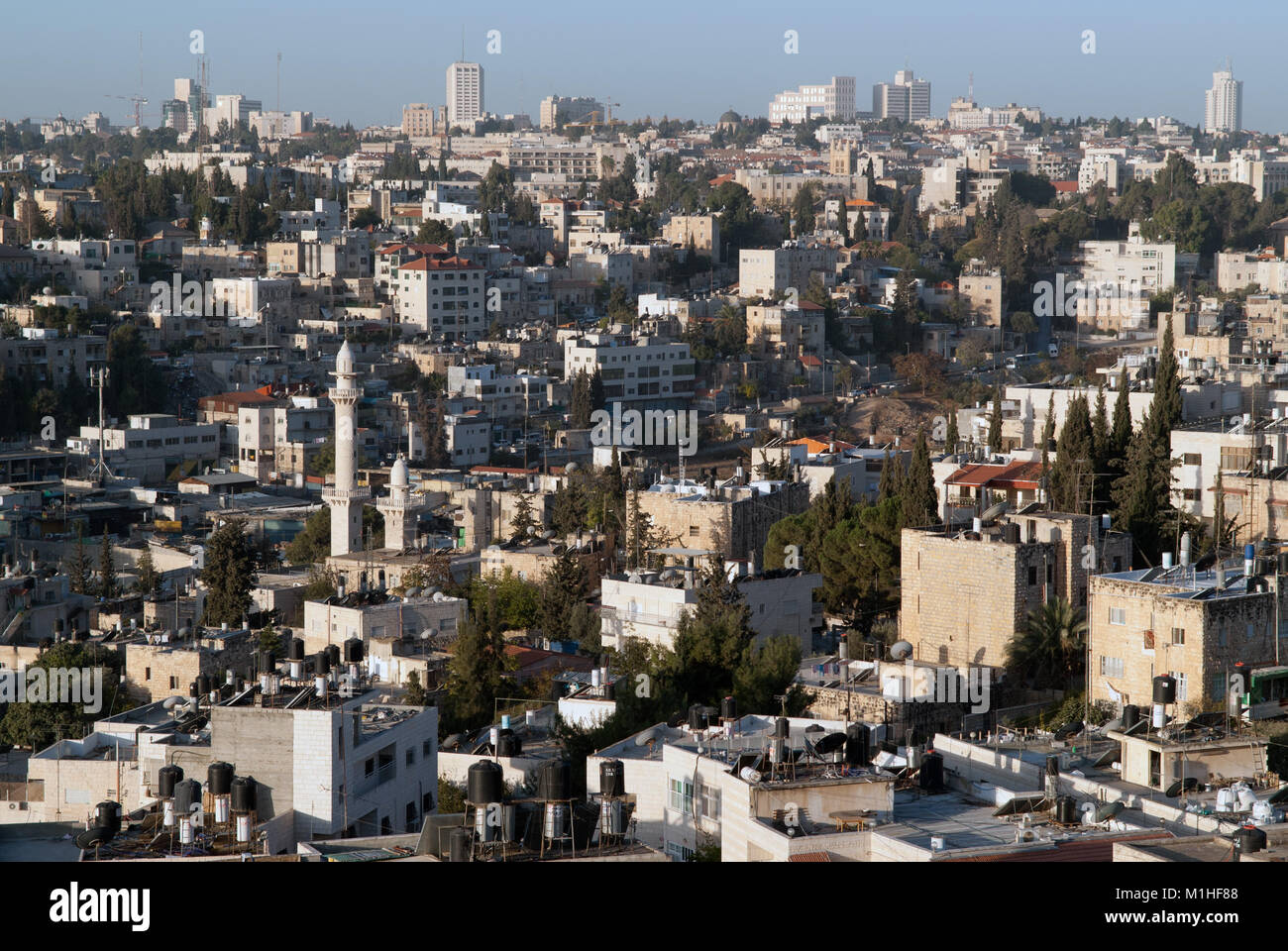 Newly built quarters of the city of Jerusalem, stone buildings of houses with white walls and different colors of the roof, are close to each other, I Stock Photo