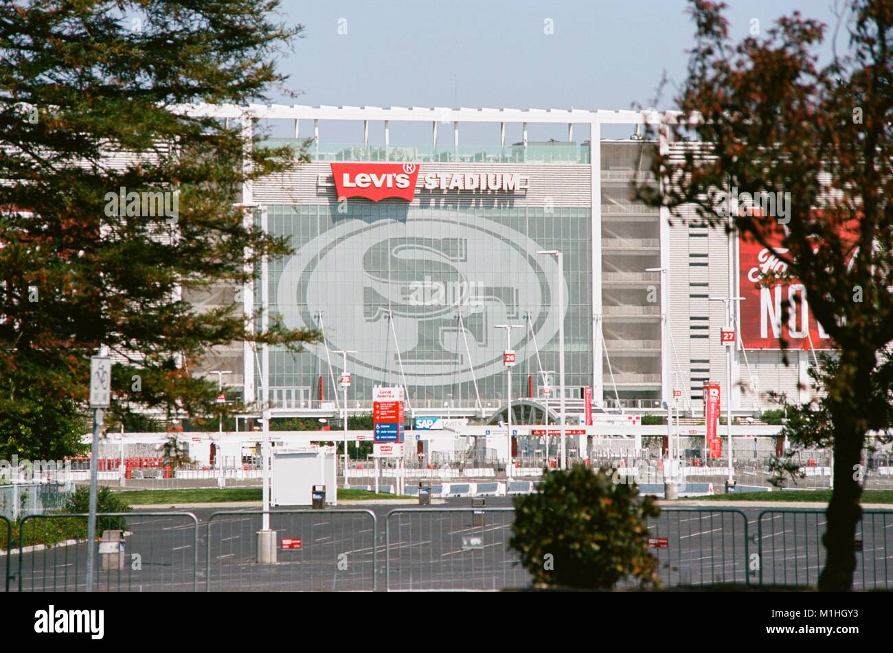 Side view of Levi's Stadium, home of the San Francisco 49ers football team, viewed through trees across a parking lot, in the Silicon Valley, Santa Clara, California, August 17, 2017. () Stock Photo