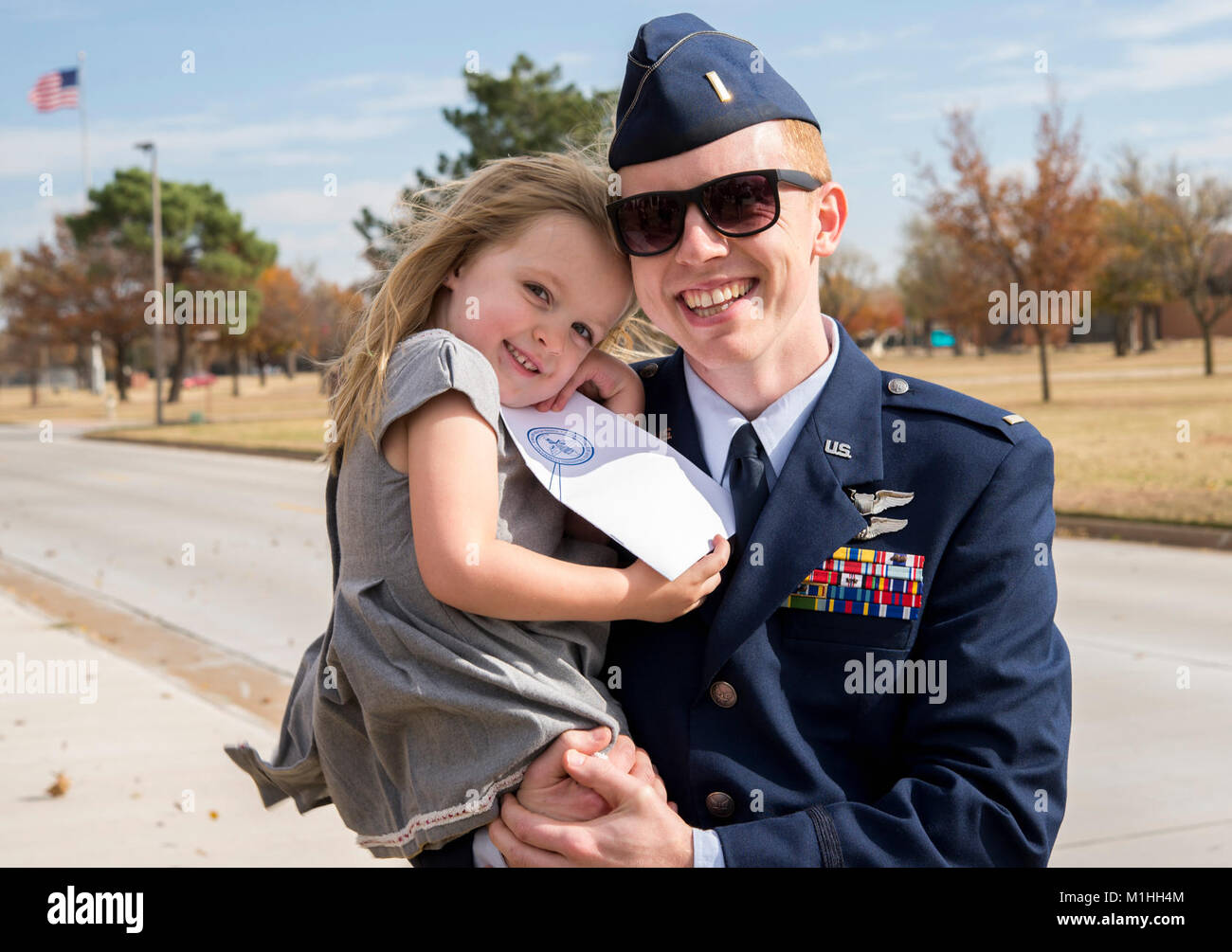 2nd Lt.Noah Boeder and his daughter Ella smile for a Stock Photo