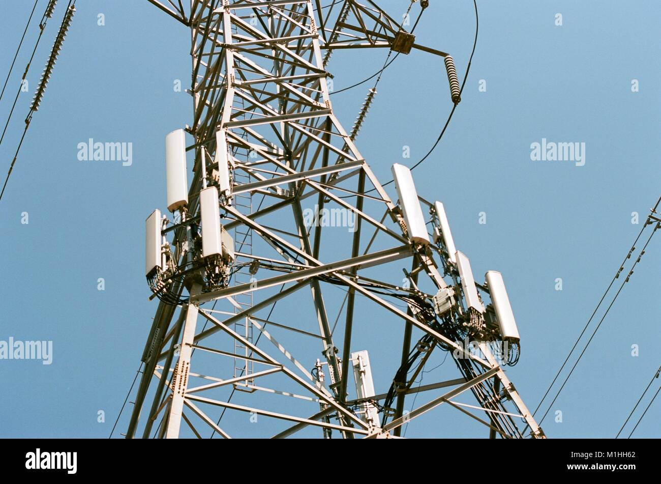 Cellular telephone transmission tower (cellphone) antennas and other hardware are installed on the side of a high tension electrical pylon in the Silicon Valley, Fremont, California, August 17, 2017. () Stock Photo