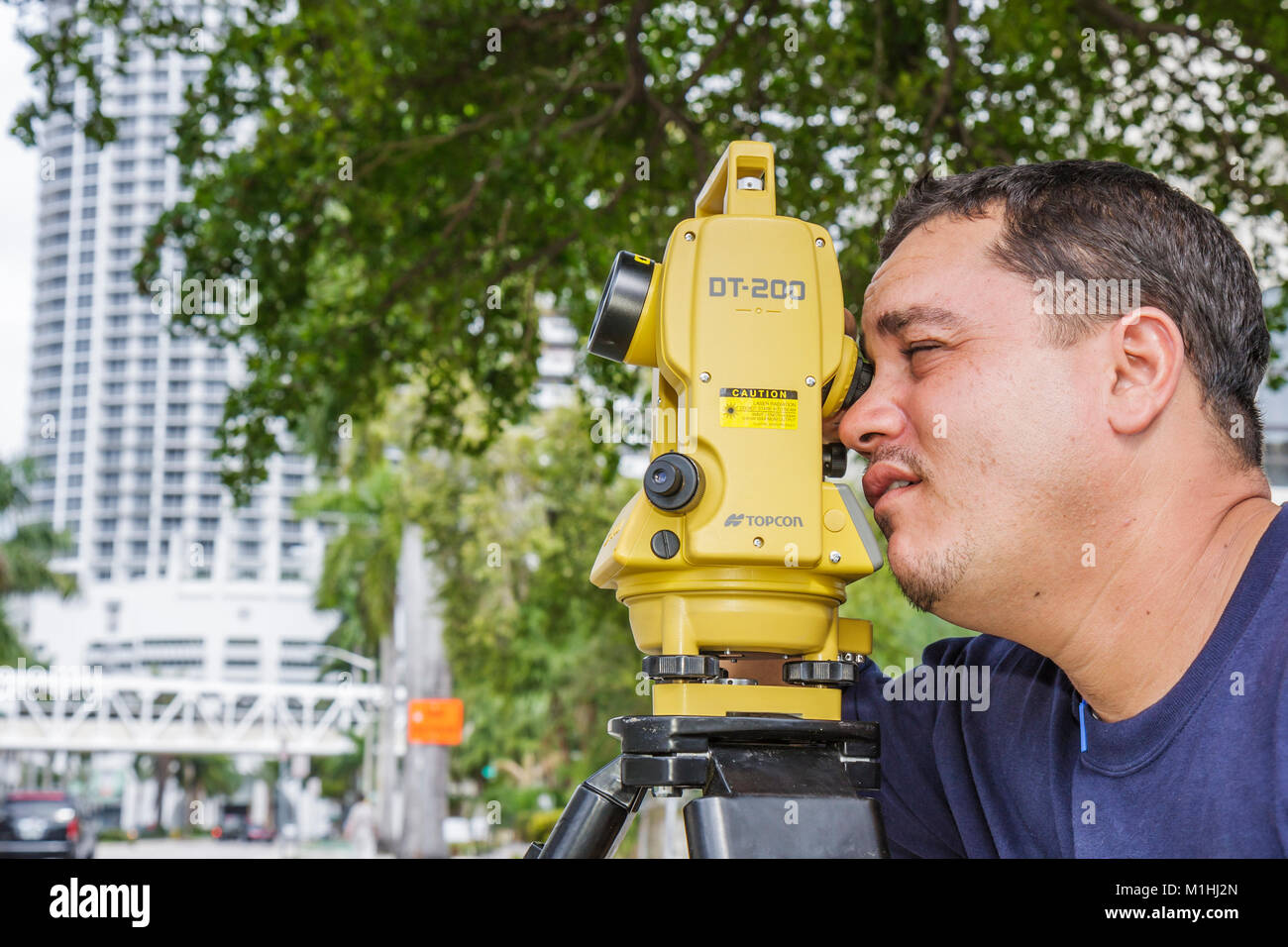 Miami Florida,theodolite,measures angles,Hispanic man men male,survey,interview,interviews,interviewing,Topcon,working,work,employee worker workers st Stock Photo