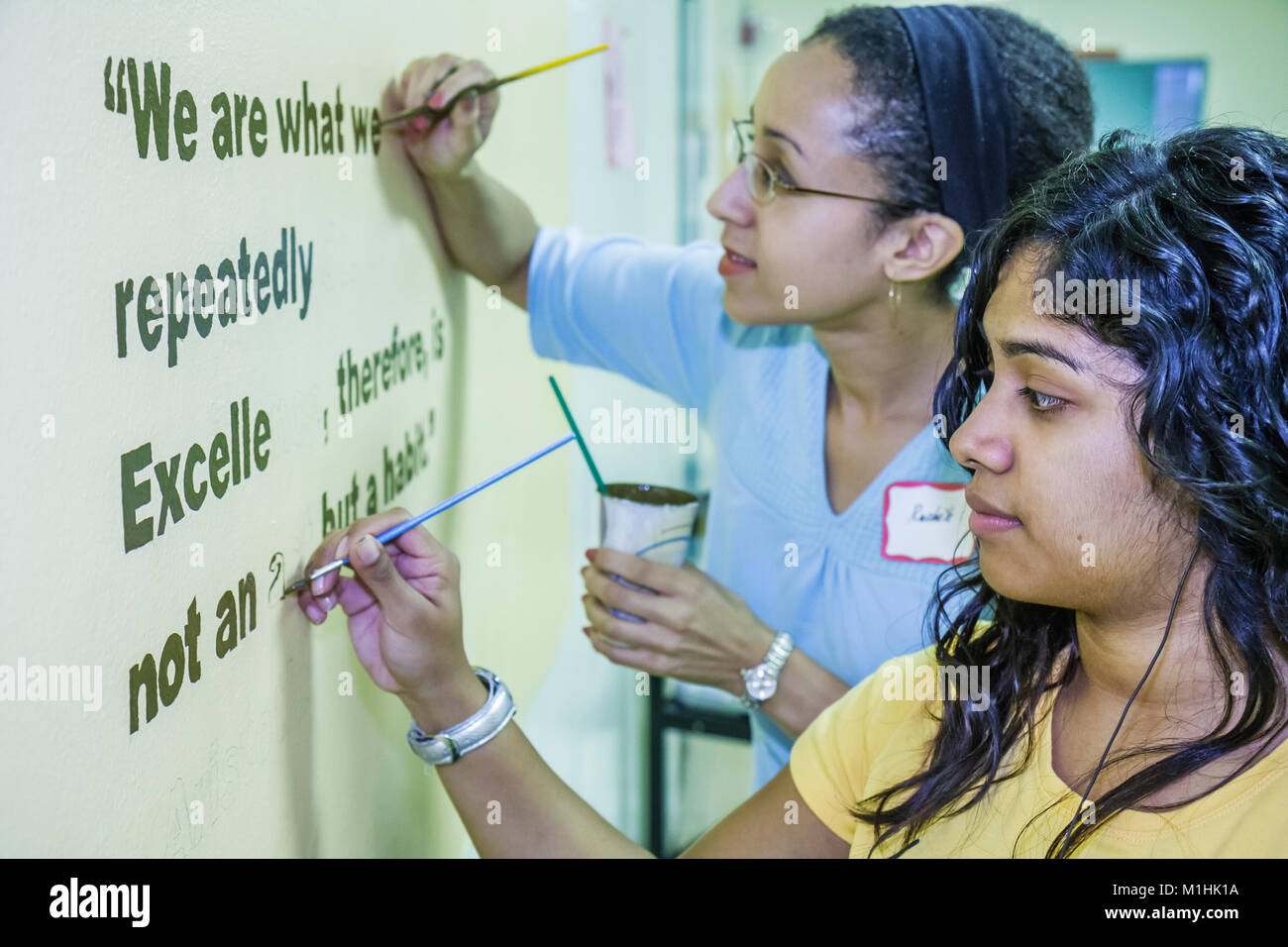 A middle school Hispanic teen girl work on her picture at a free