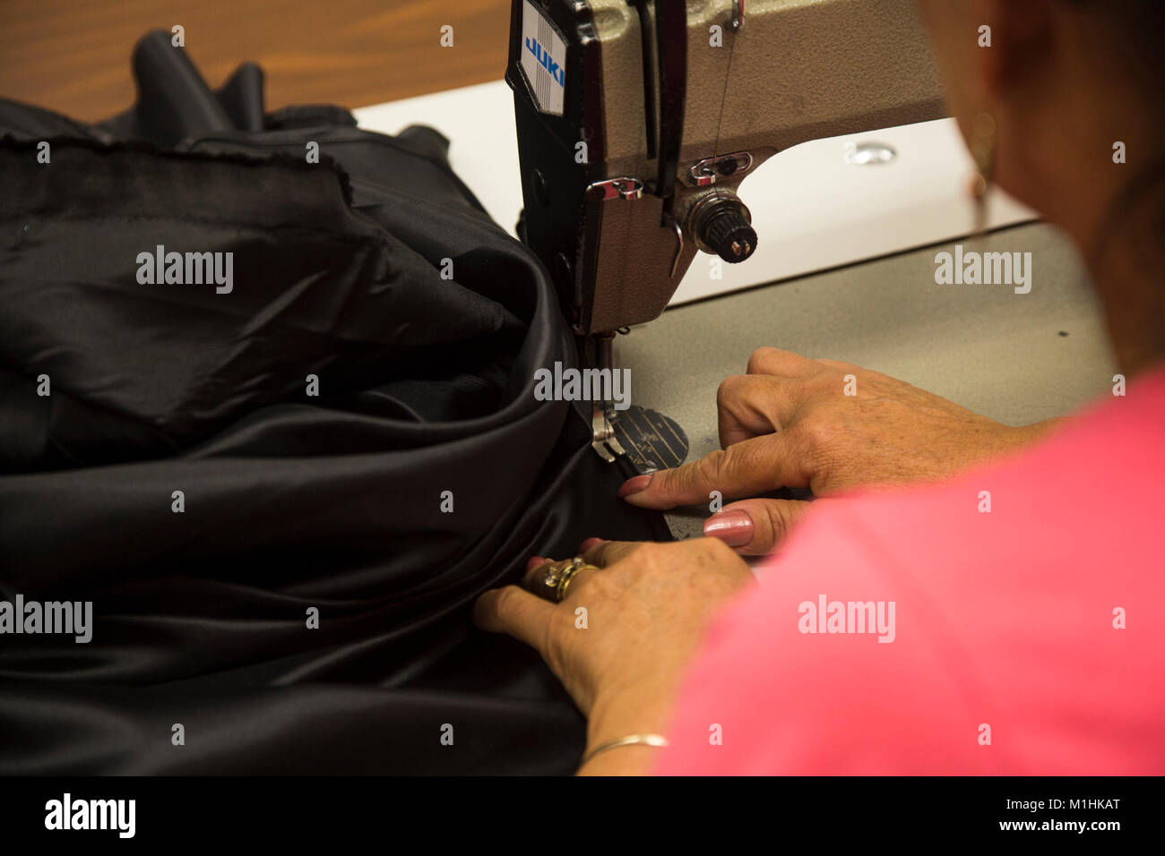 Isabel Andrade, a seamstress at the station drycleaners, alters a pair of U.S. Marine Corps
