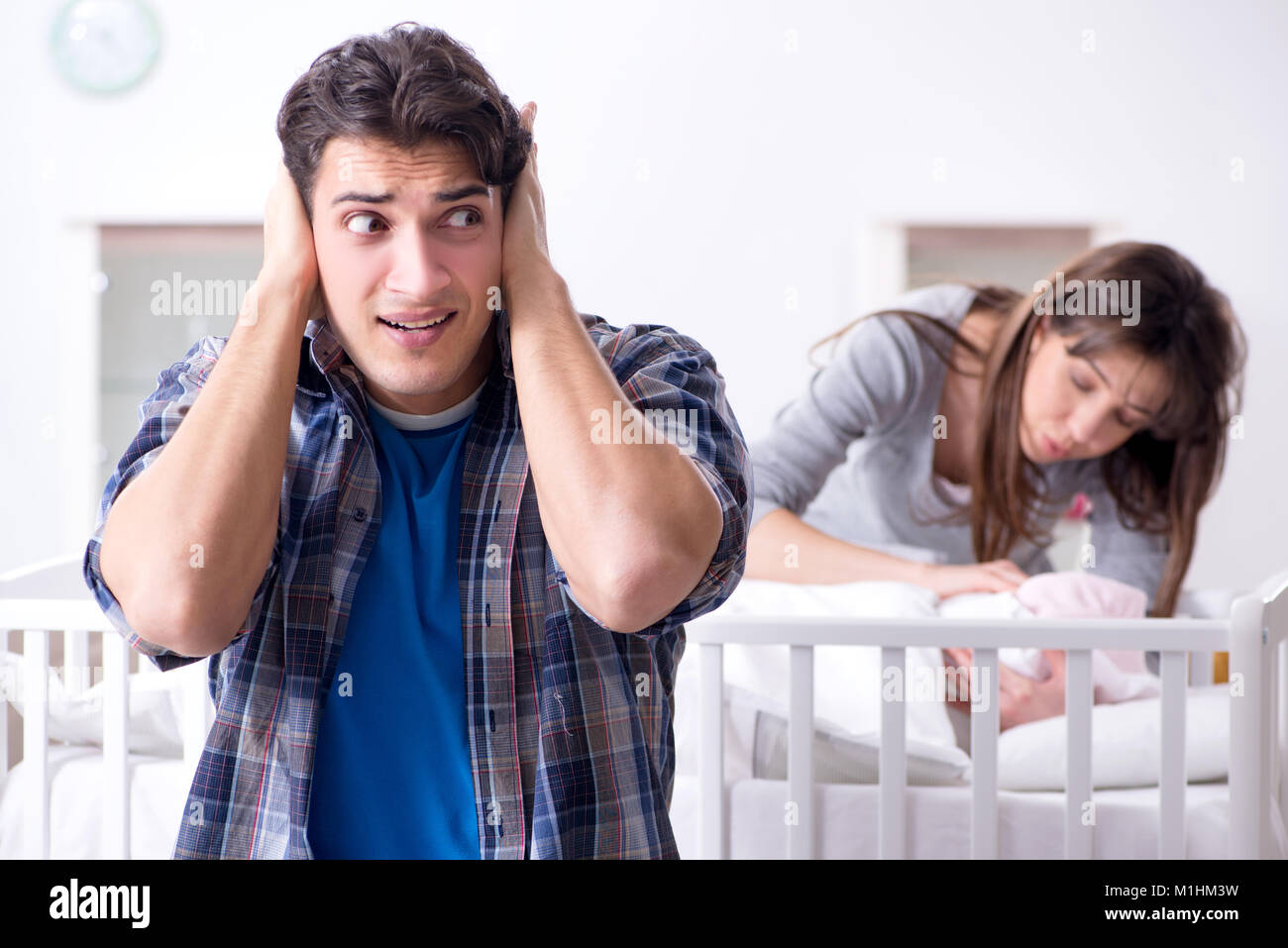 Young dad cannot stand baby crying Stock Photo - Alamy