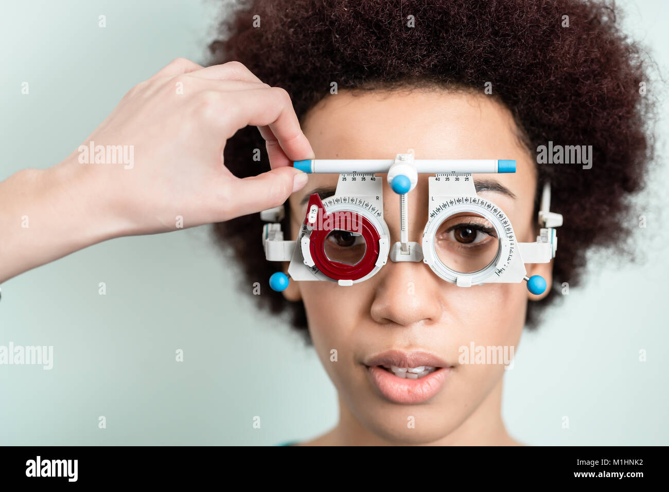 Woman having eyesight test with phoropter for new glasses Stock Photo
