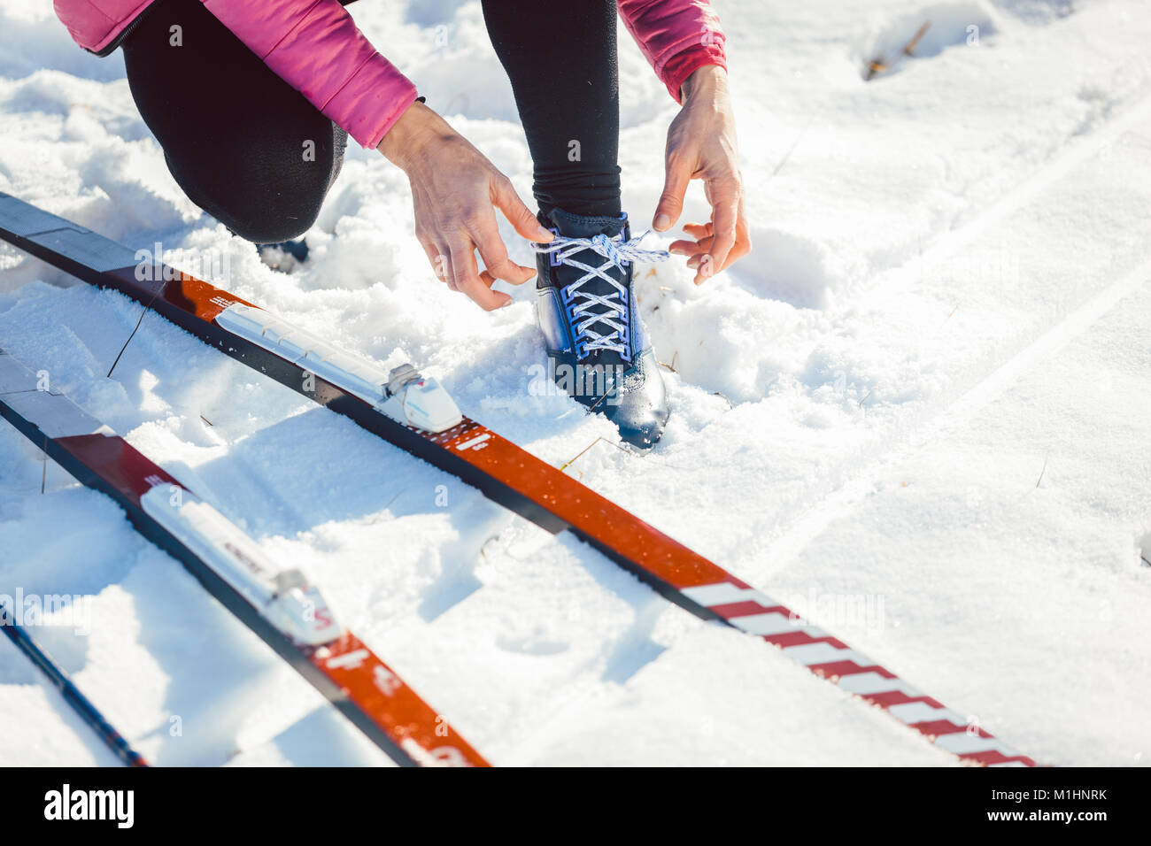 Woman cross country skier putting on ski Stock Photo Alamy