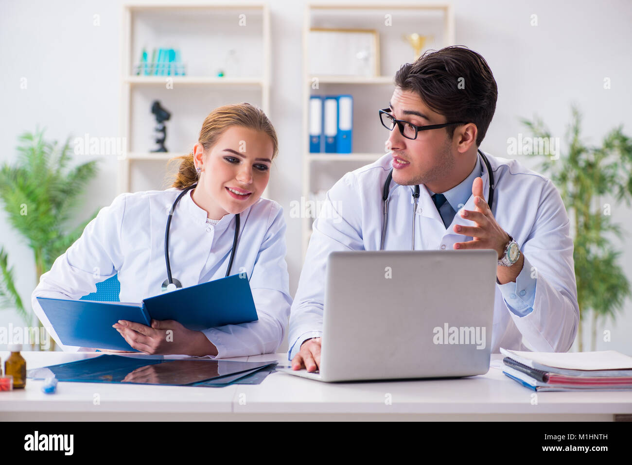 Male and female doctor having discussion in hospital Stock Photo - Alamy