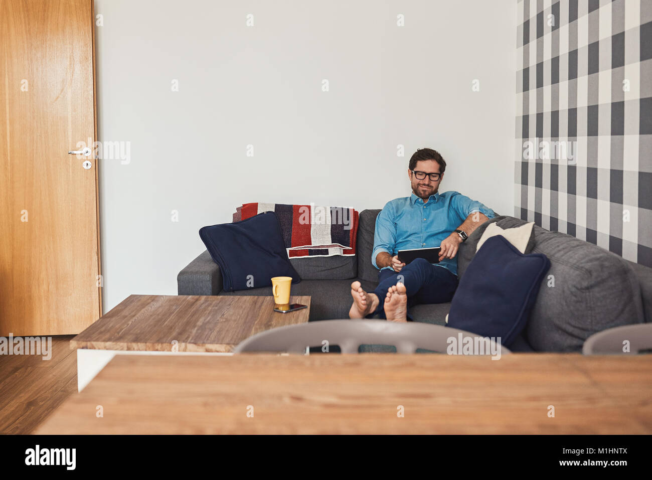 Man lying on the sofa hi-res stock photography and images - Alamy