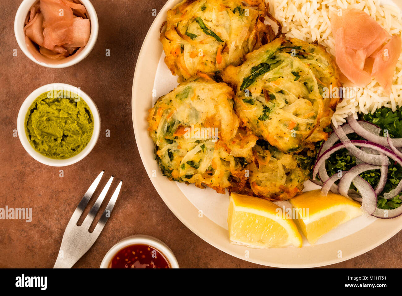 Vegetable Deep Fried Japanese Style Tempura With Rice and Salad On A Red Tiled Background Stock