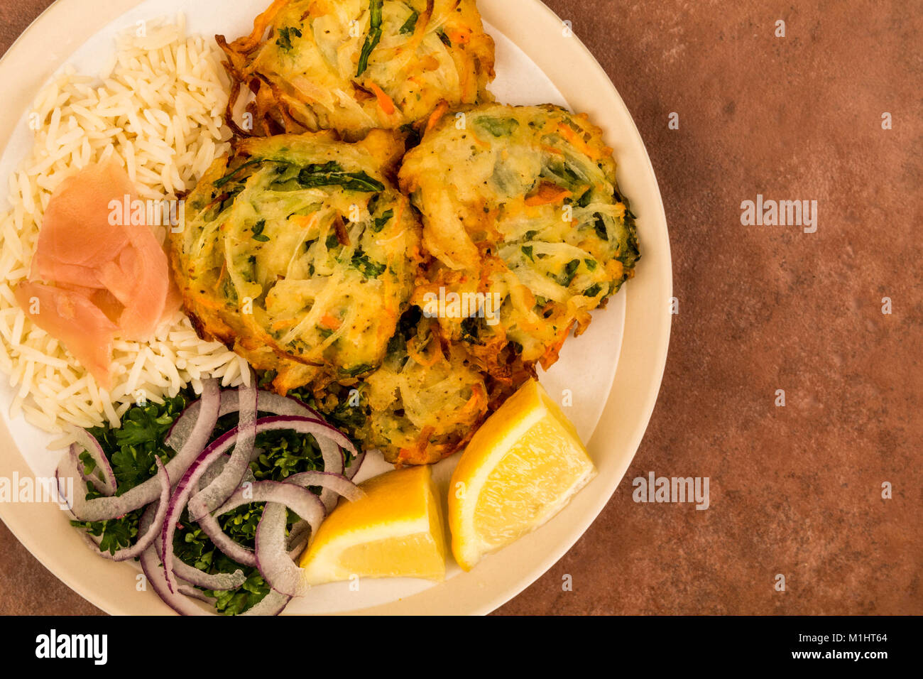 Vegetable Deep Fried Japanese Style Tempura With Rice and Salad On A Red Tiled Background Stock