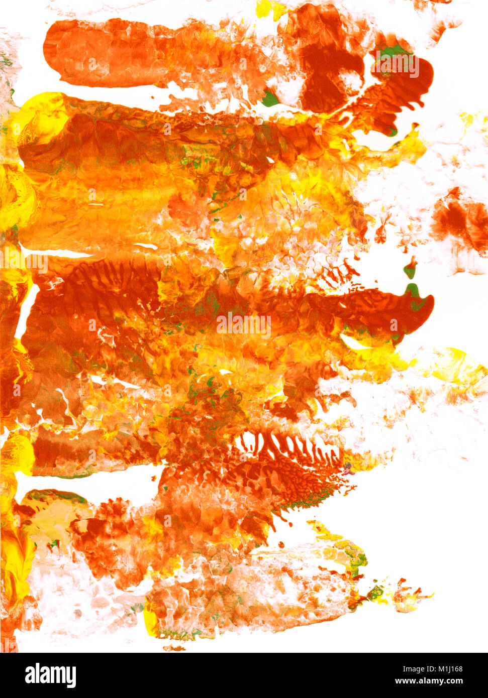 Abstract patches of red, orange and yellow paint on white paper ...