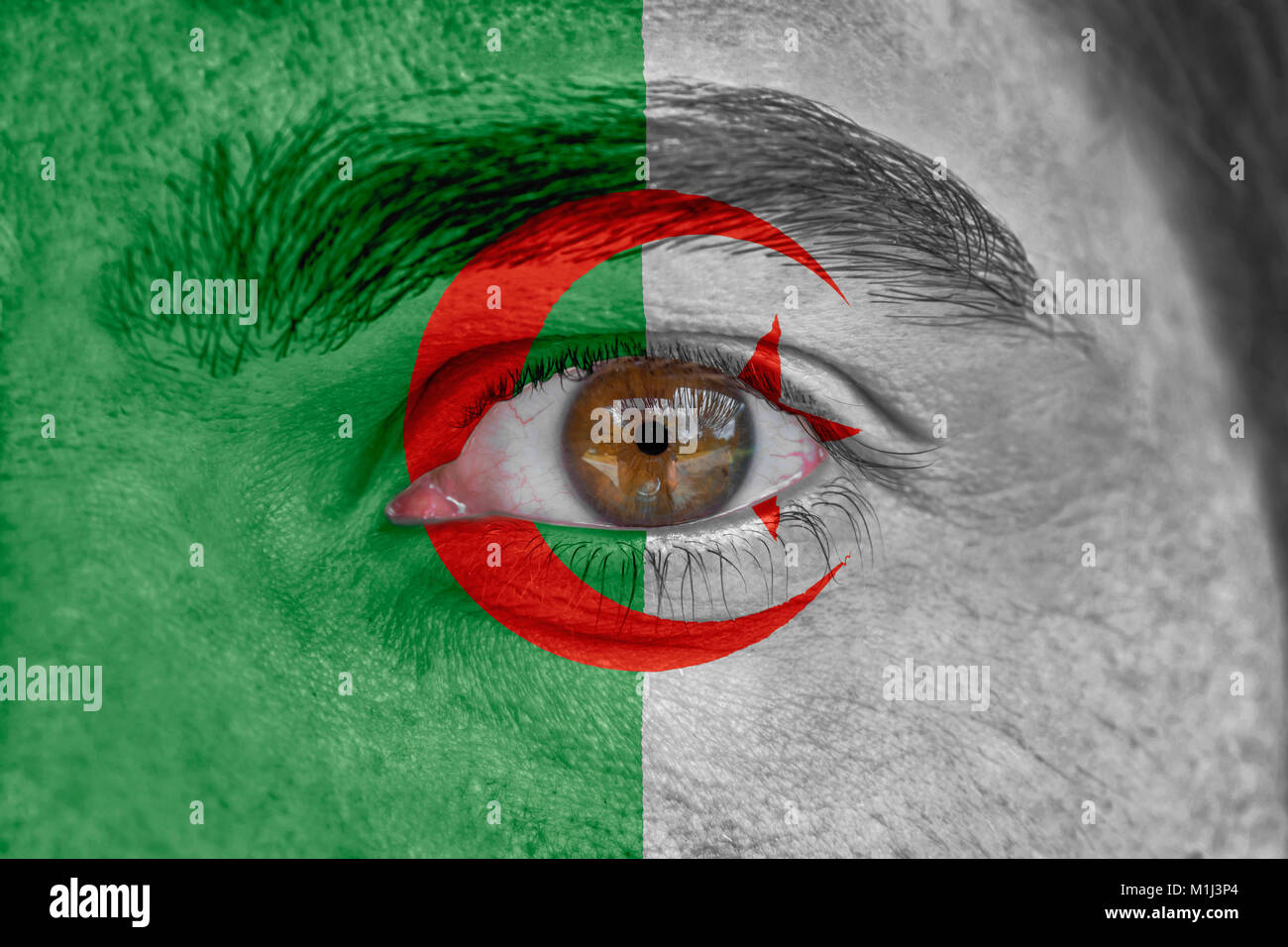 Human face and eye painted with flag of Algeria Stock Photo