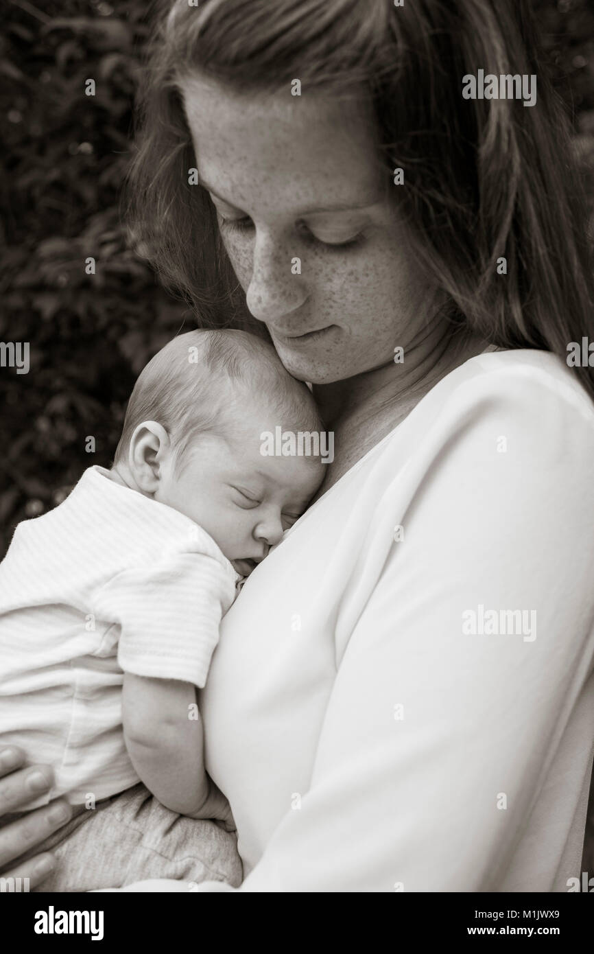 Mother Holding Newborn Baby Stock Photo