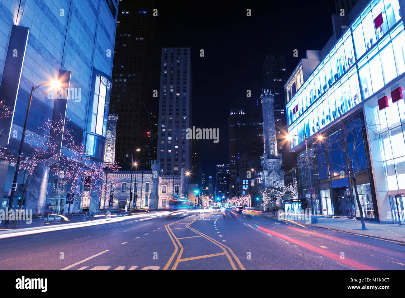 Night city scene in Chicago downtown in the street with light trails