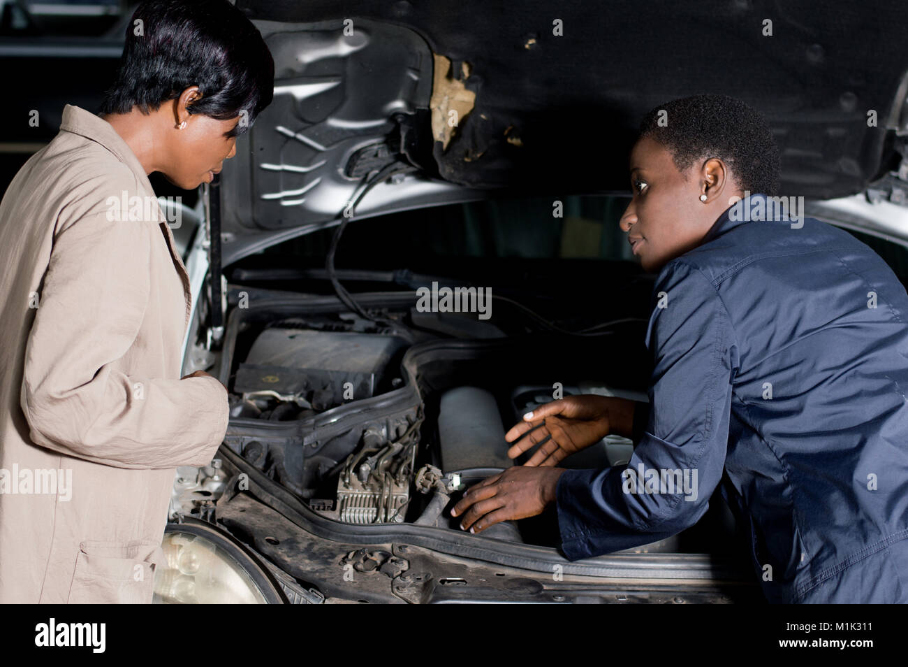 The mechanic explains the breakdown of the car to its owner at the ...
