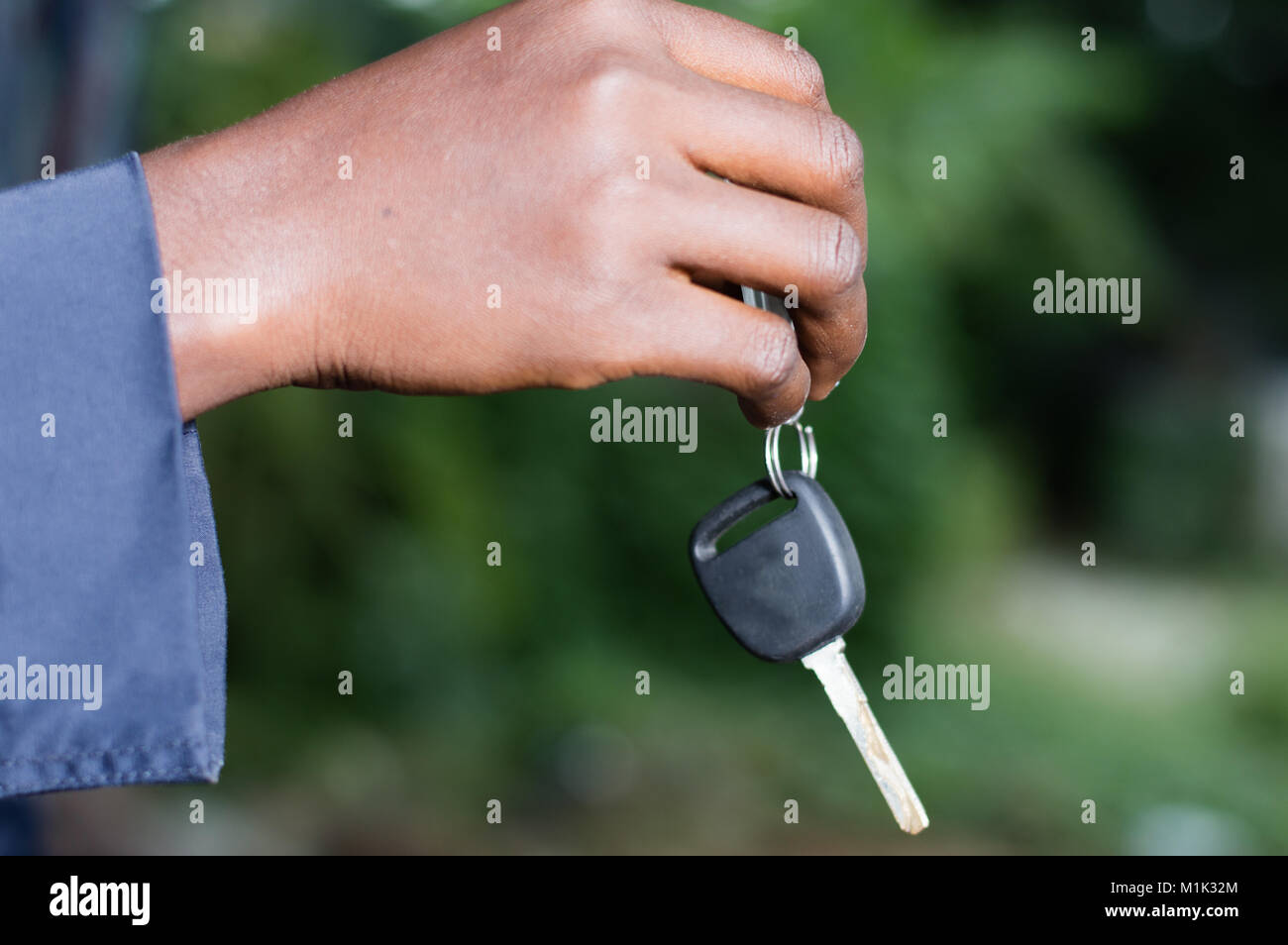 a hand holding a car ignition key outside Stock Photo Alamy