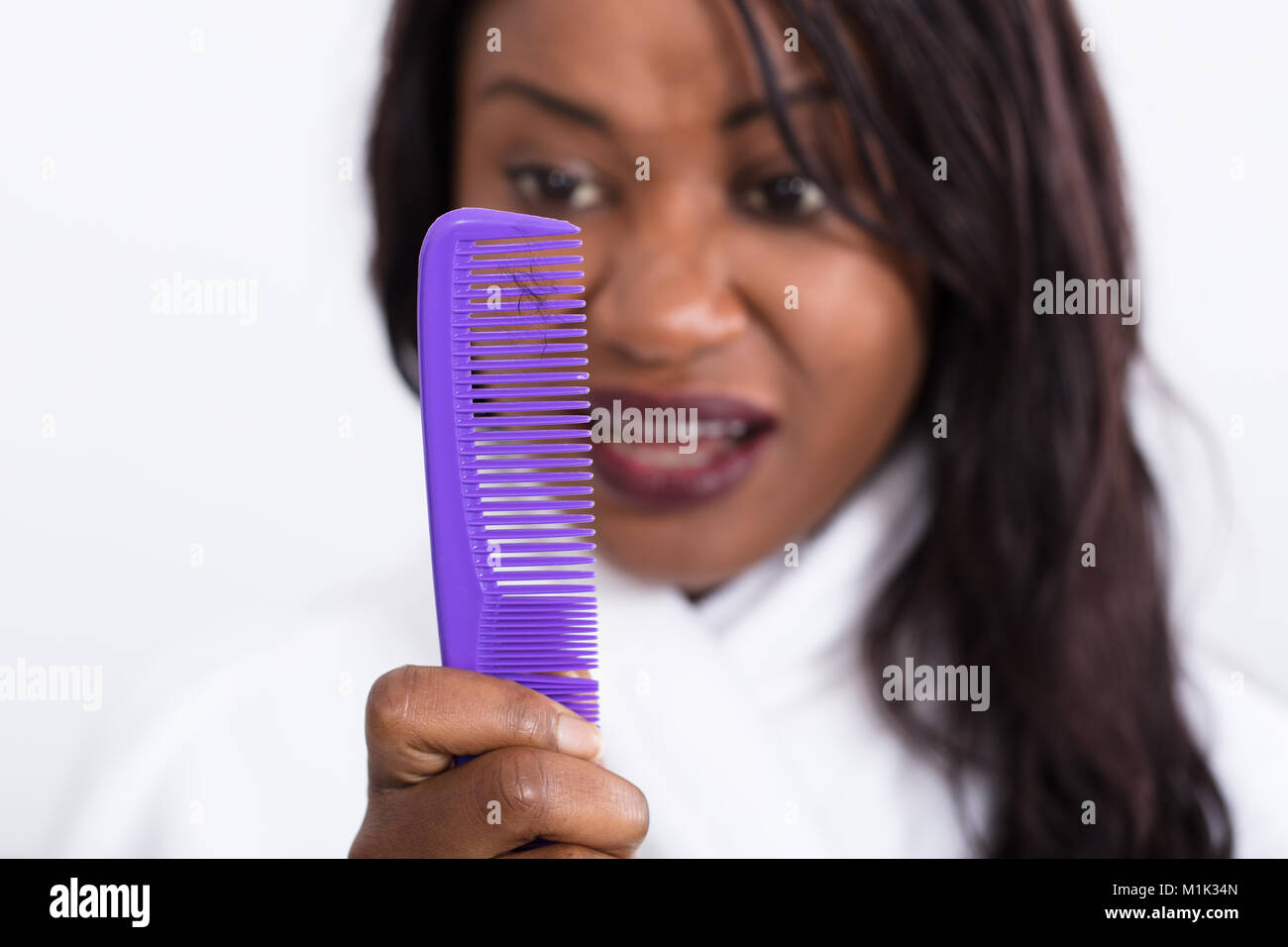 Woman Holding Comb Looking At Loss Hair Stock Photo
