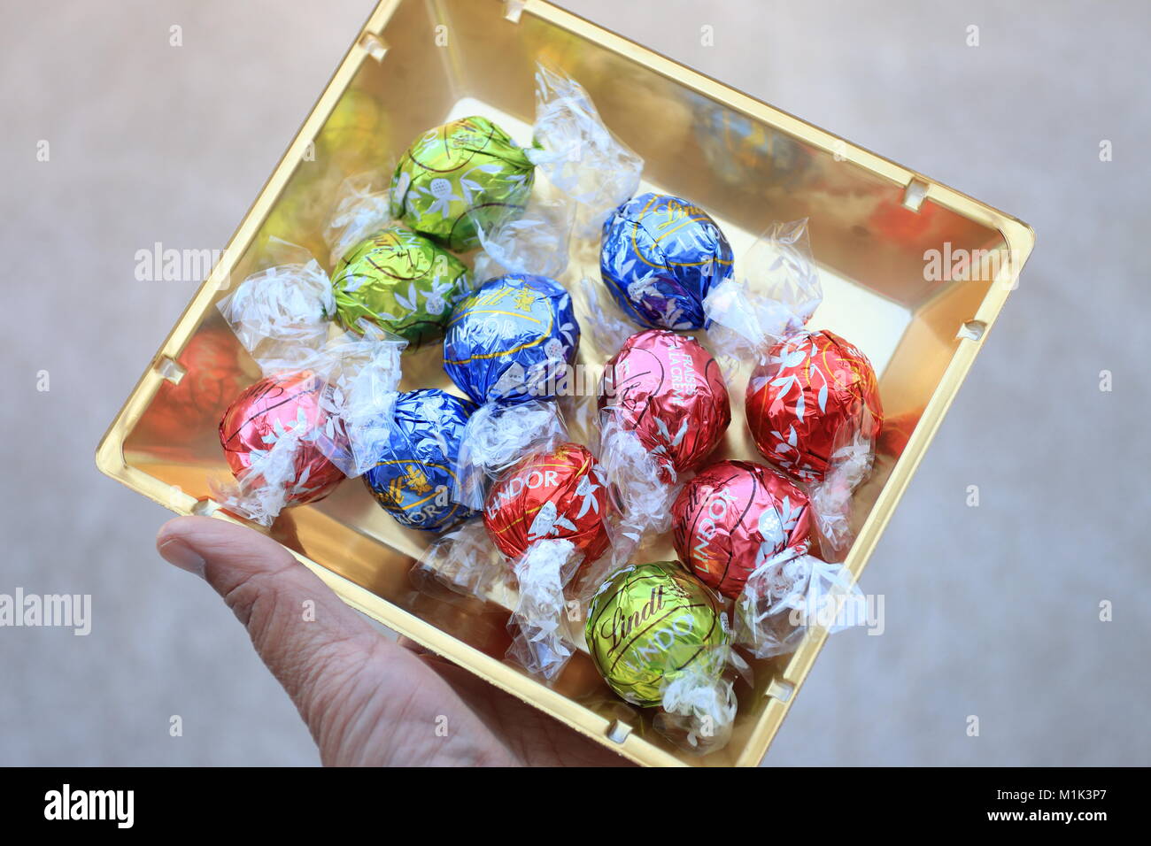 Close up of Assorted Lindt Lindor Chocolates in gold colour box Stock