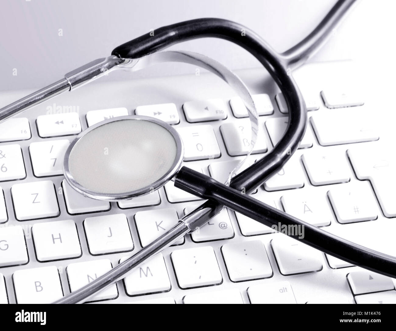 It support, stethoscope and computer keyboard or keypad. Close-up shot of medical equipment. Stock Photo