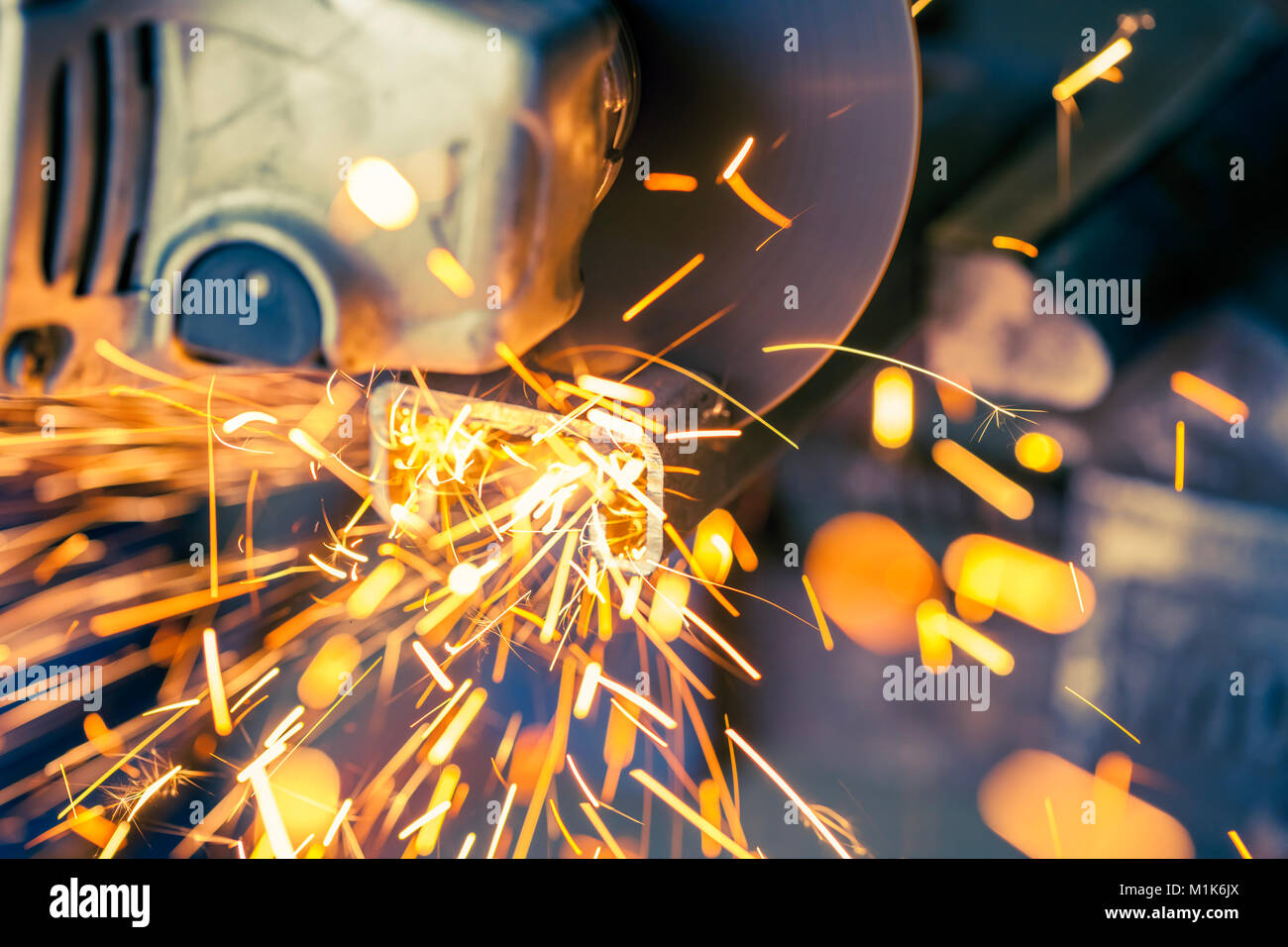 Soft focus with sparks flying from metal being cut with electric grinder Stock Photo