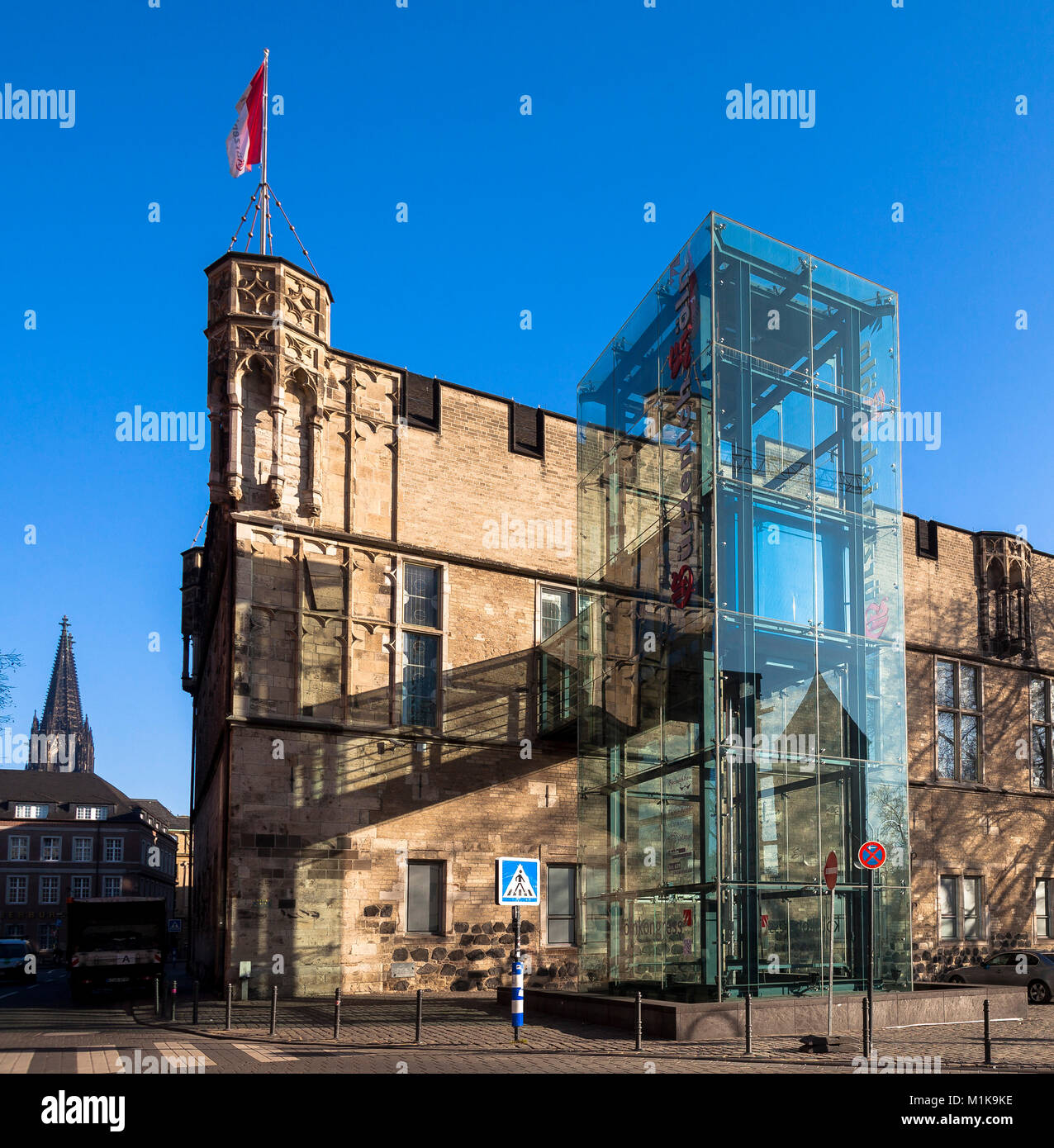Germany, Cologne, the Guerzenich building with glass freight elevator in the historic town, on the left the cathedral.  Deutschland, Koeln, der Guerze Stock Photo