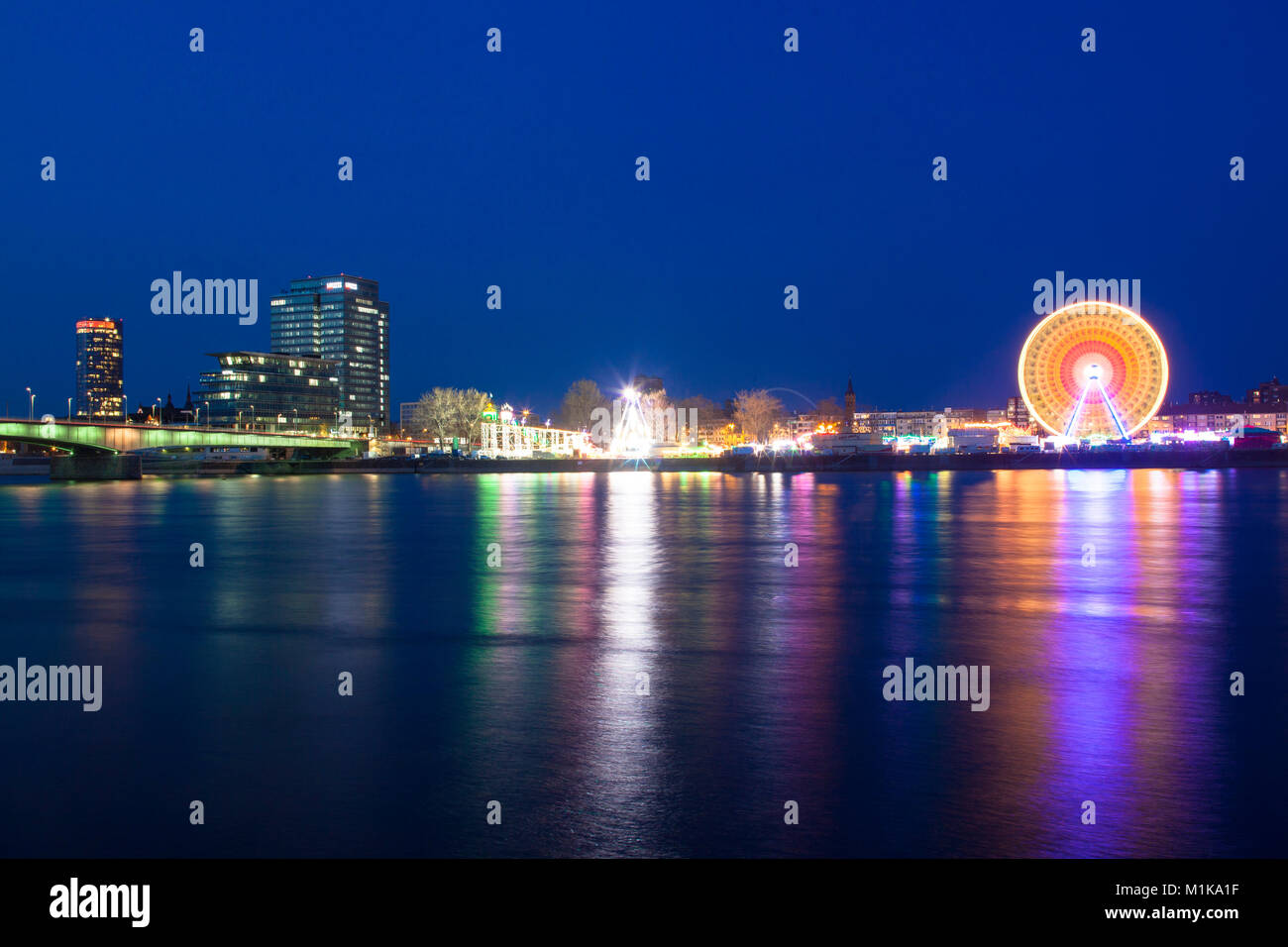 Germany, Cologne, view across the river Rhine to the kermis in the district Deutz, at left the CologneTriangle Tower and the Lanxess Tower, Deutzer br Stock Photo