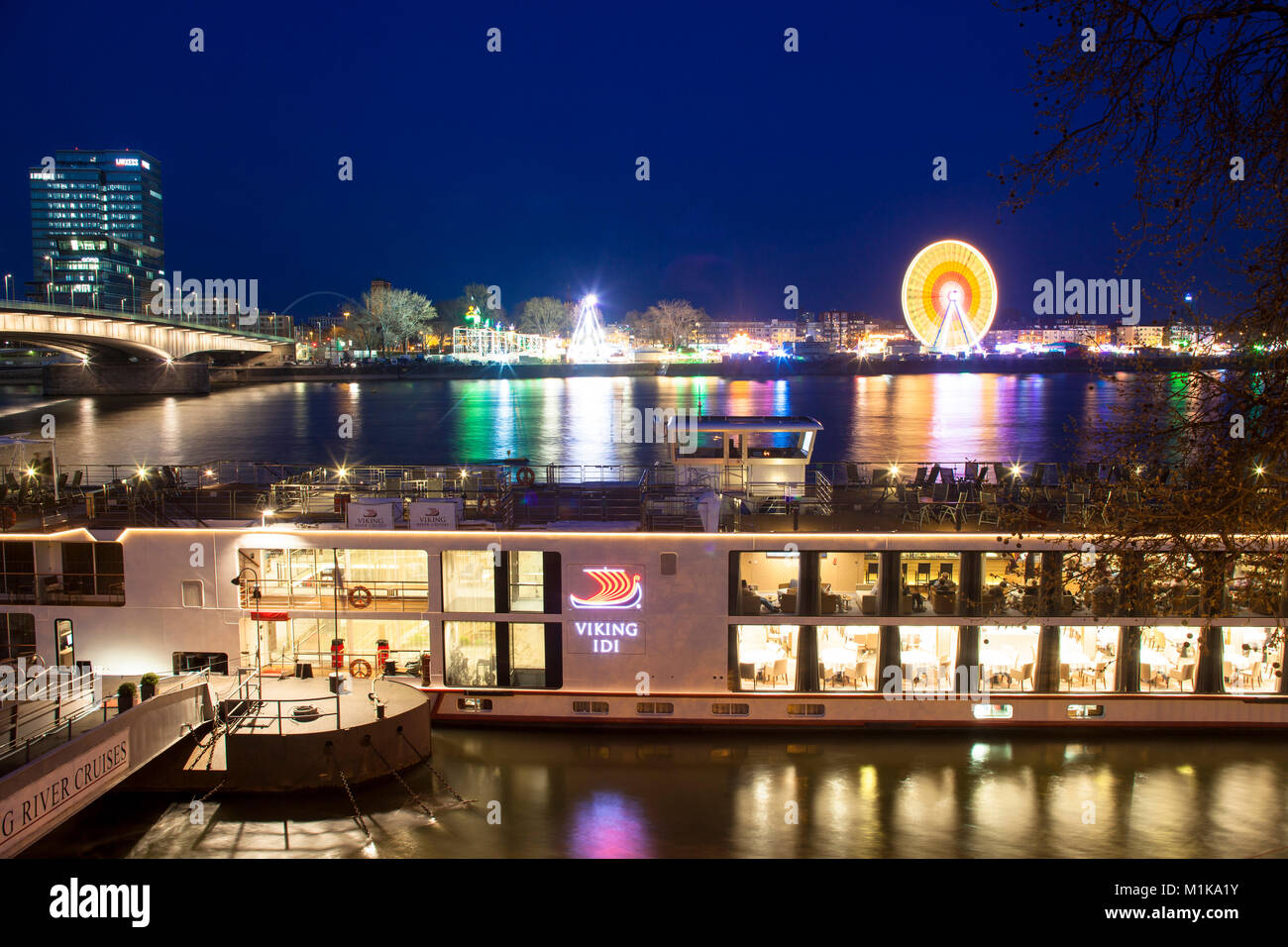 Germany, Cologne, view across the river Rhine to the kermis in the district Deutz, at left the Lanxess Tower, Deutzer bridge.  Deutschland, Koeln, Bli Stock Photo