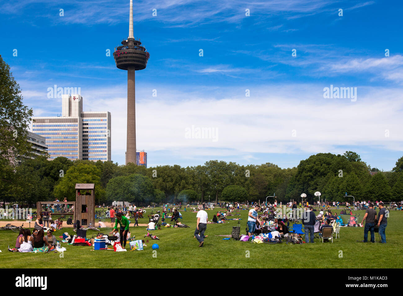 Germany, Cologne, people enjoying a summer day at the Innerer Gruenguertel, Colonius television tower.  Deutschland, Koeln, Menschen geniessen einen S Stock Photo