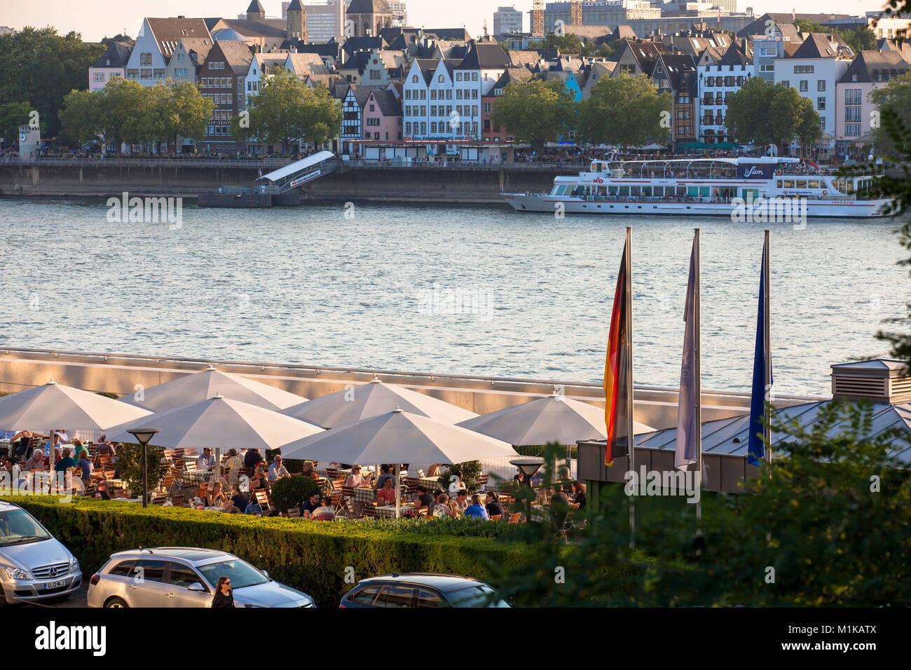 Germany, Cologne, beer garden at the Hyatt hotel in the town district Deutz, view across the river Rhine to the historic town part.  Deutschland, Koel Stock Photo