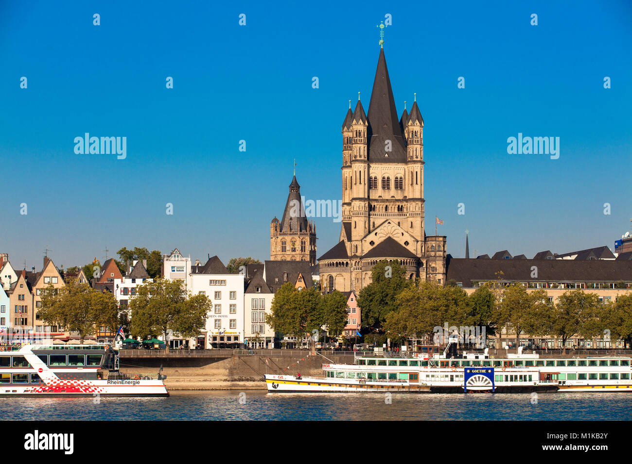 Germany, Cologne, view across the river Rhine to the Frankenwerft in the old part of the town with the steeple of the historic town hall and the roman Stock Photo