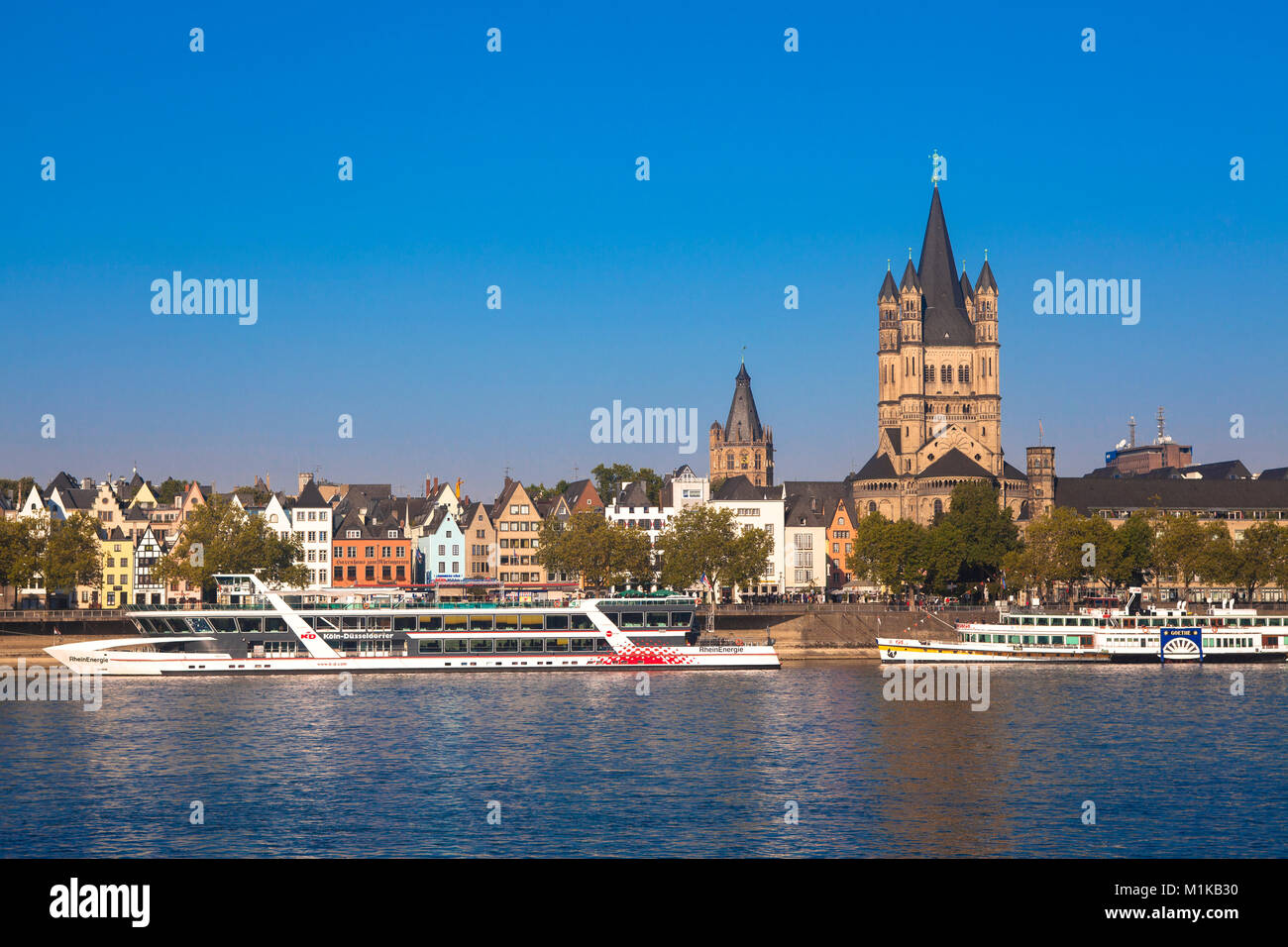 Germany, Cologne, view across the river Rhine to the Frankenwerft in the old part of the town with the steeple of the historic town hall and the roman Stock Photo