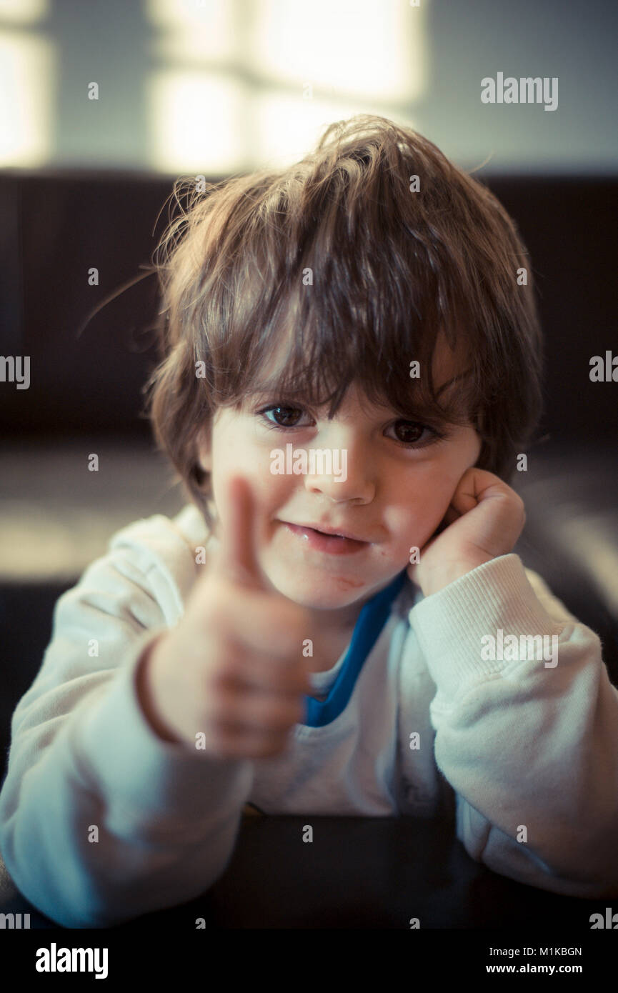 Portrait Of 5 Year Old Boy At Home Making Thumbs Up Gesture Ok Stock Portrait Of 5 Year Old Boy At Home Making Thumbs Up Gesture Ok Stock